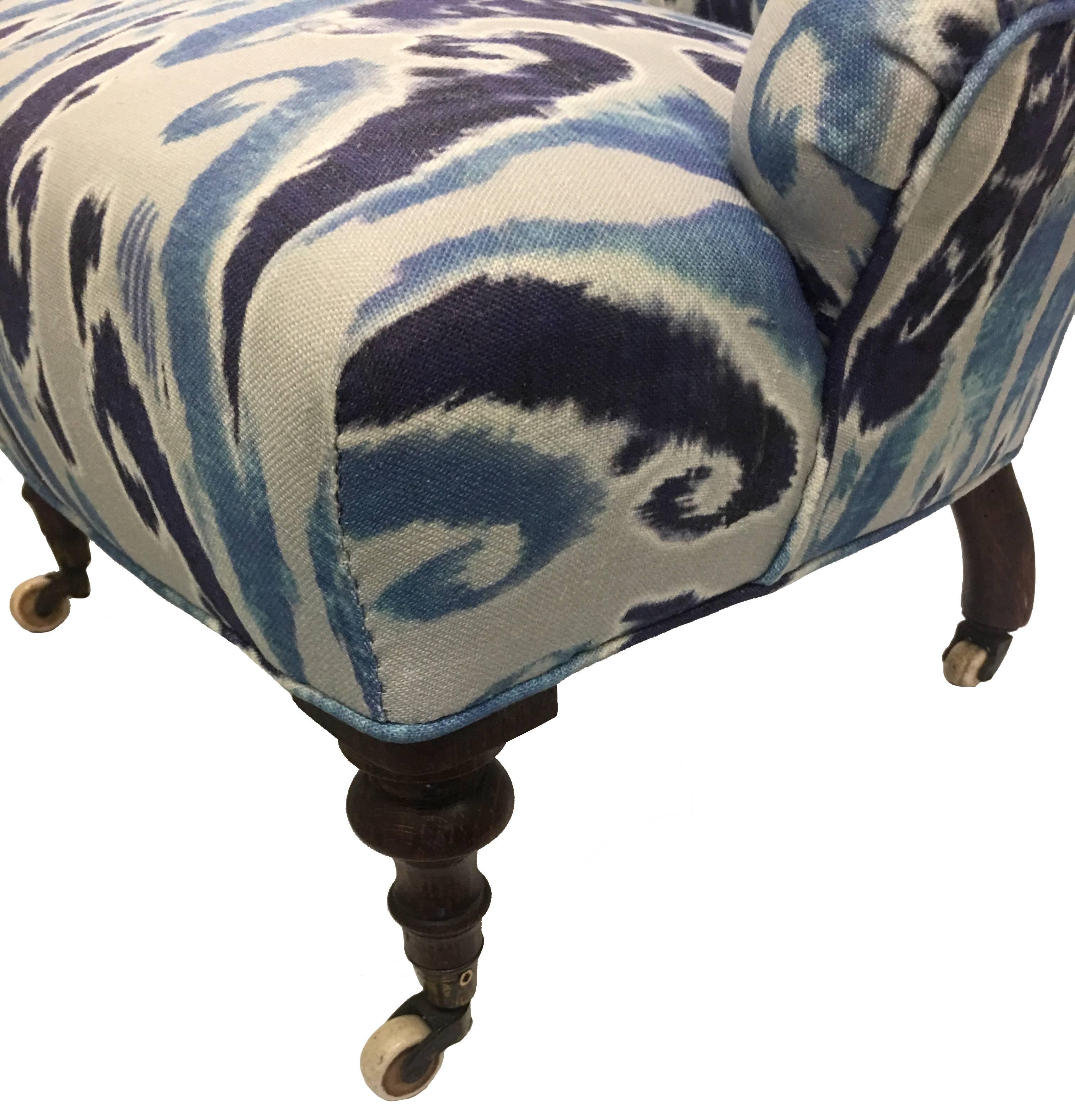Rare 1880s child's size upholstered slipper chair. Newly upholstered in Old World Weavers 'Island Ikat' linen. Original ceramic castors on all four feet. Seat is 10" tall x 13.5" deep.