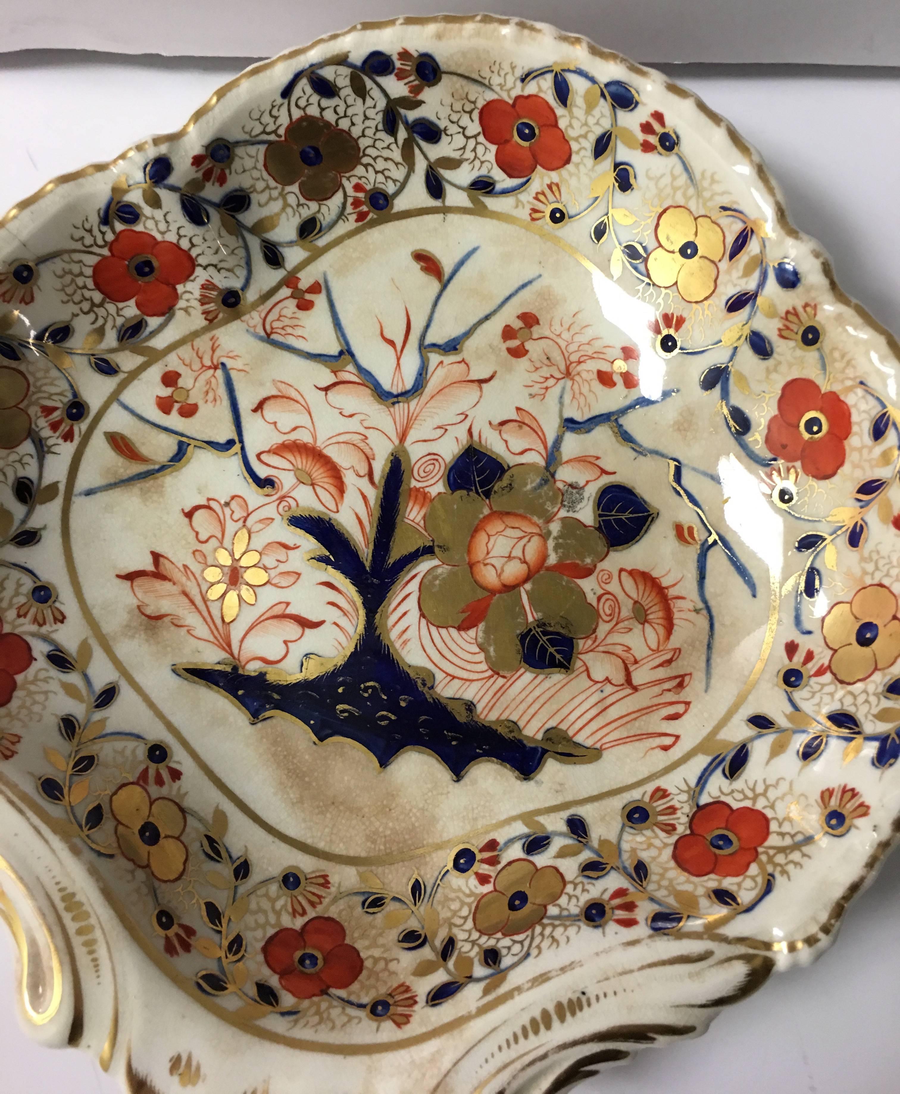 Early Royal Crown Derby Gadroon Asian Rose porcelain dessert dish. Scalloped edges with 22-karat gold painted detailing. All-over chinoiserie style floral pattern. Full Derby mark in red on the underside.