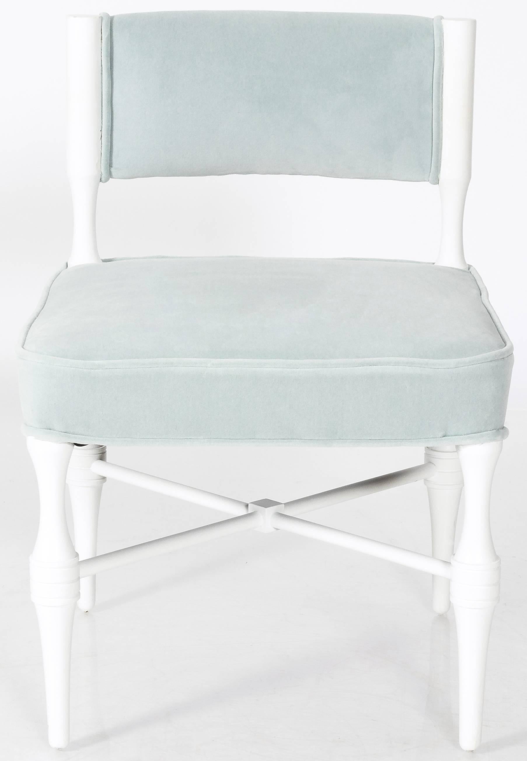 Pair of Tommi Parzinger petite slipper or vanity chairs. White painted frames. Newly upholstered in light blue cotton velvet by Rogers & Goffigon. No makers mark or signature. Chairs are only available as a pair (will not split set).