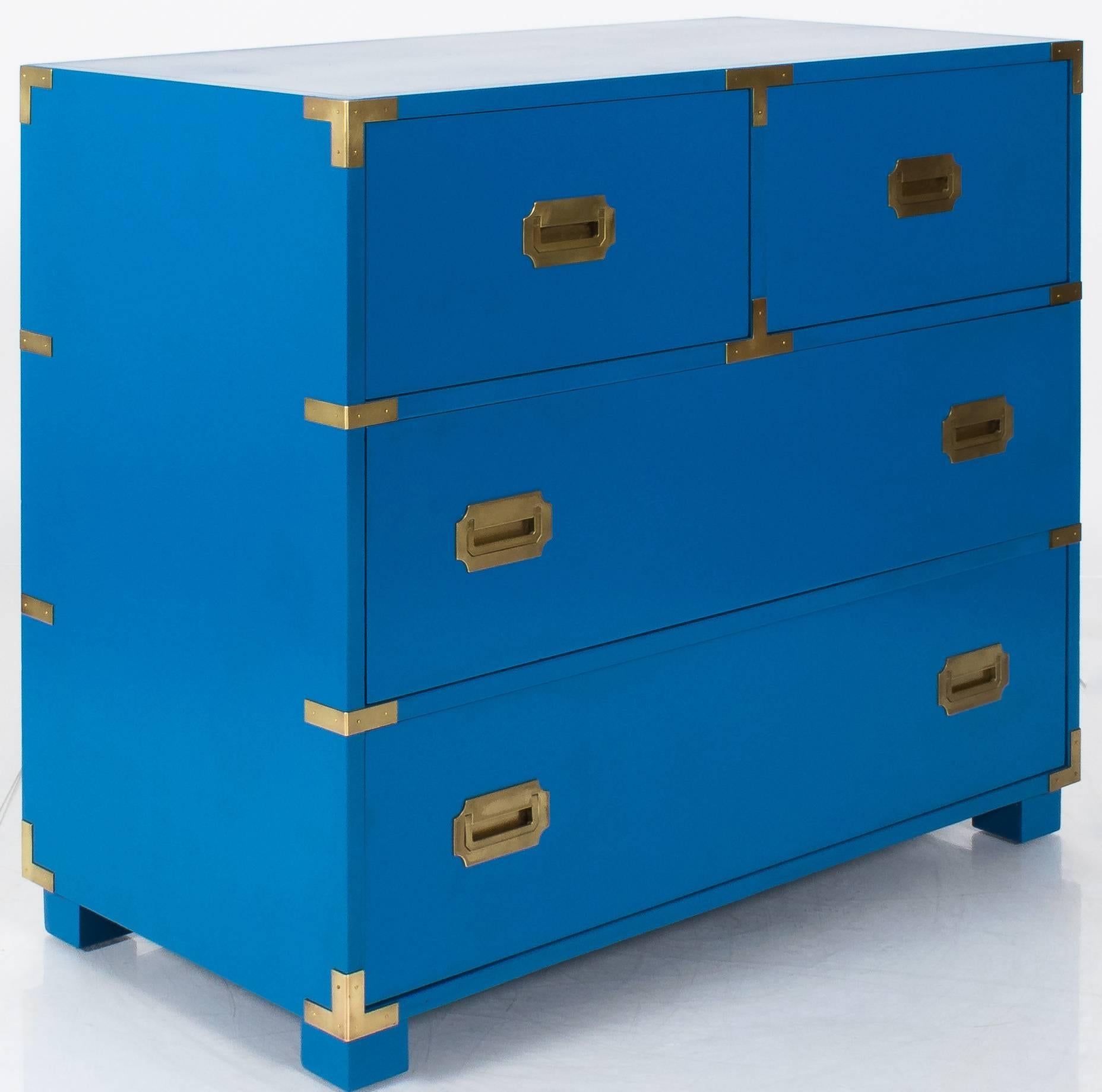 1970s Campaign dresser by Baker. Newly refinished in satin blue (BM 'Old Glory'). Brass hardware is newly hand polished. Dresser retains metal Baker tag in upper left drawer. Four drawer style. Upper left drawer has divided compartment (as shown).