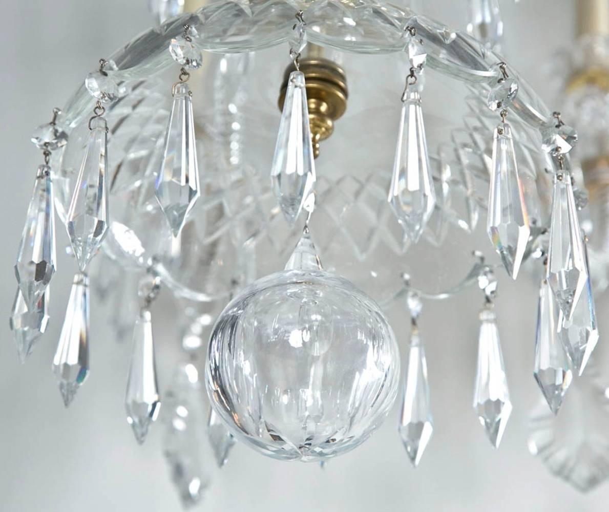 Large crystal chandelier by Swarovski. As seen in the movie "The Patriot" (2000). Originally one of a pair, circa 1990. Eight light and three spear. Brass fittings and canopy. Newly rewired. From a waterfront Greenwich, CT estate.