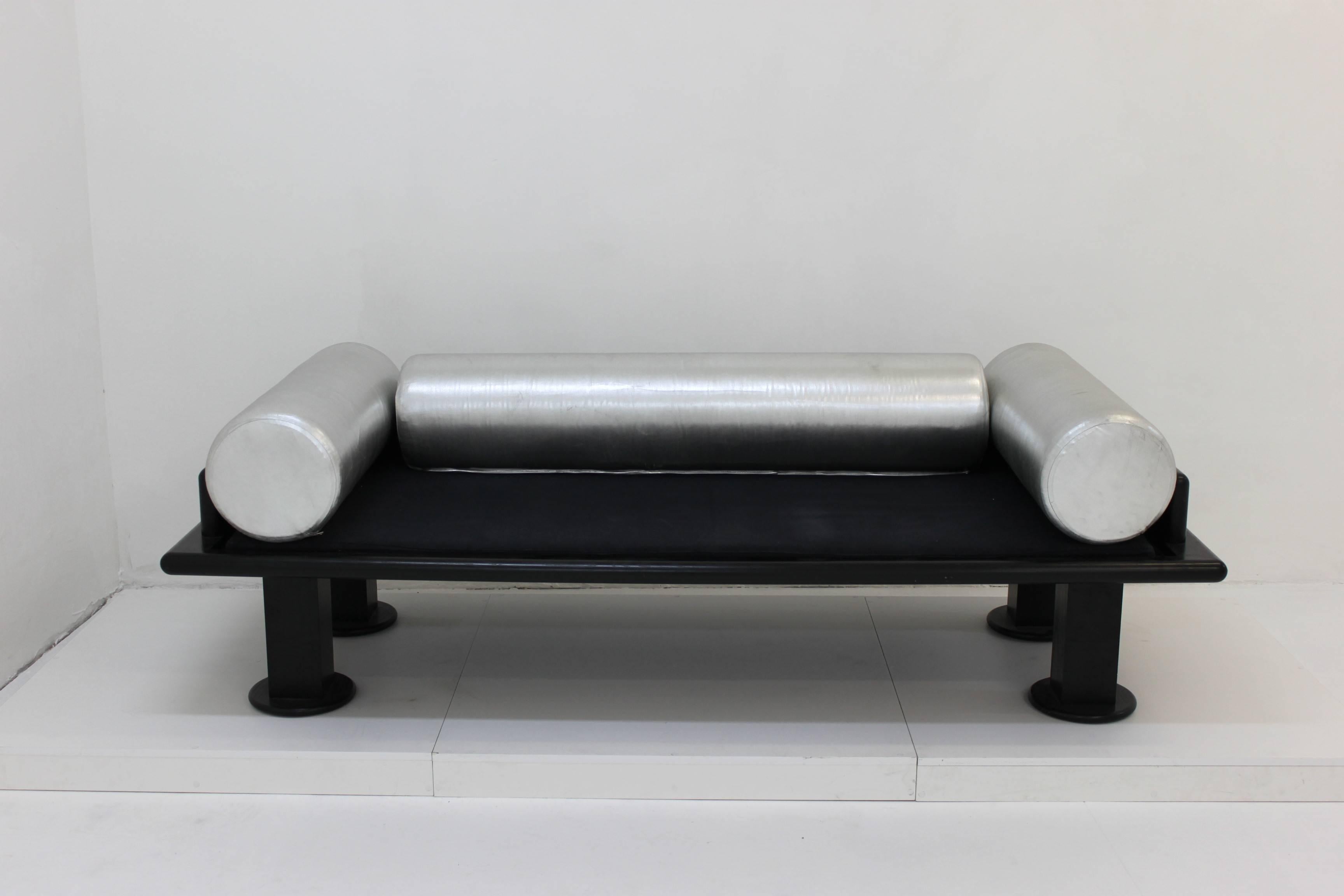 This beautiful sofa is made by Ettore Sottsass.
Black wood base and wonderful cylindrical silver pillows. 
Prototype of an edition of six pieces.
Made for the Art Exhibition 