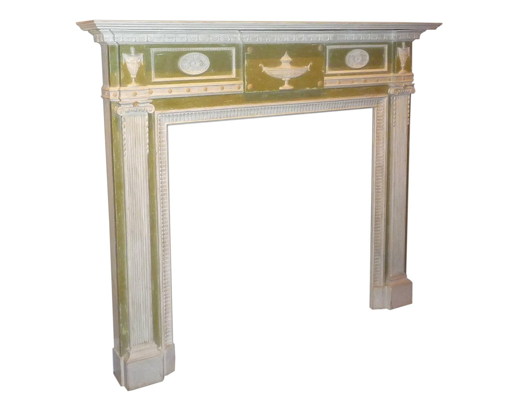 A fine English neoclassical carved and painted (white and Adam green) wood fire surround, in the style of Robert Adam, late 19th century.

Inside dimensions: Length 42