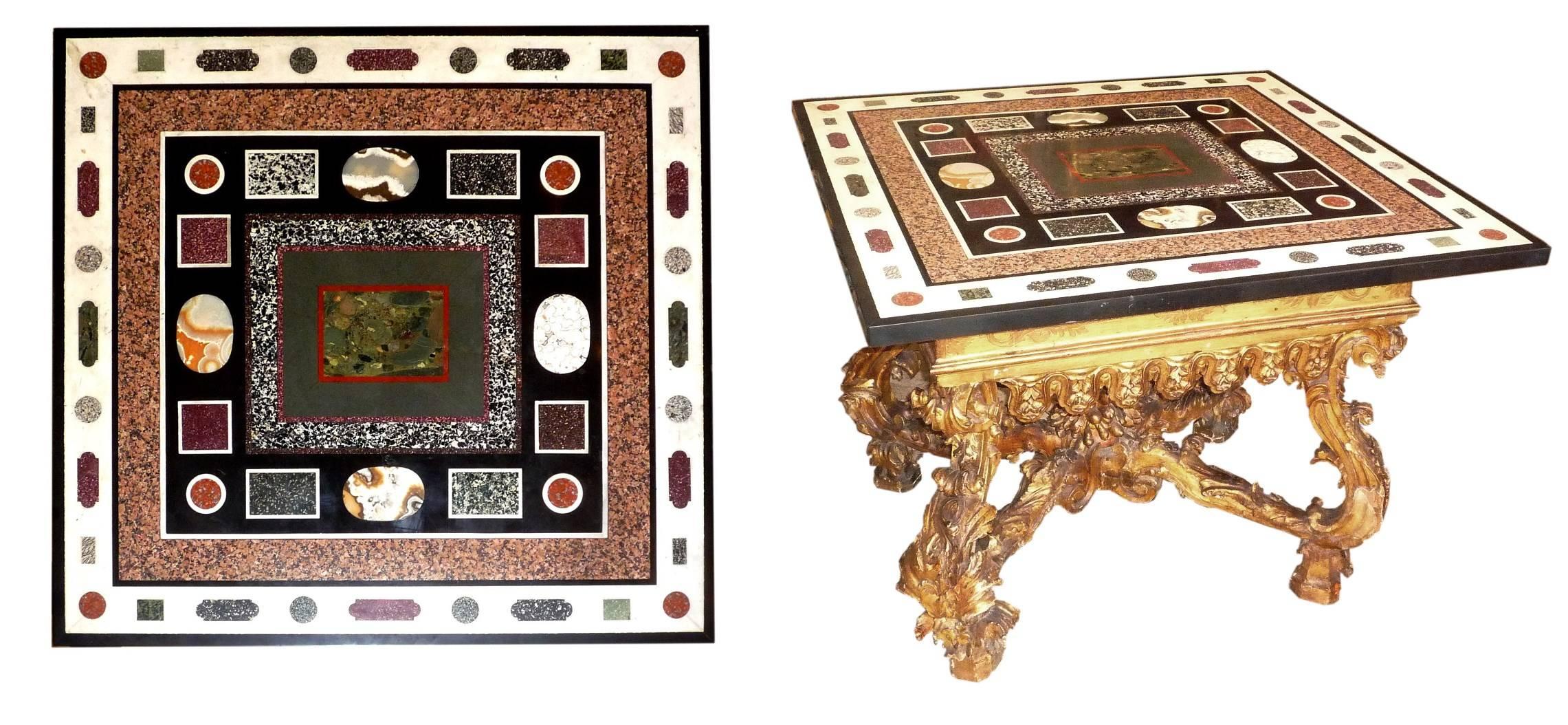 A fine Roman 19th century Pietra Dura panel, composed of red Egyptian porphyry, gray porphyry, agate, pink granite, on a black and white marble background. The table Roman Baroque in carved and giltwood, dating from the beginning of the 18th