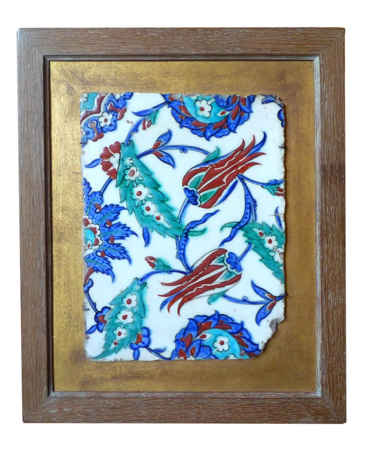A Turkish (Ottoman) rectangular tile with tulips and various flowers and palms, Iznik, circa 1580. The coral color in relief.
One corner missing. In a frame.
[For a known decor of a mosque in Istambul].
   