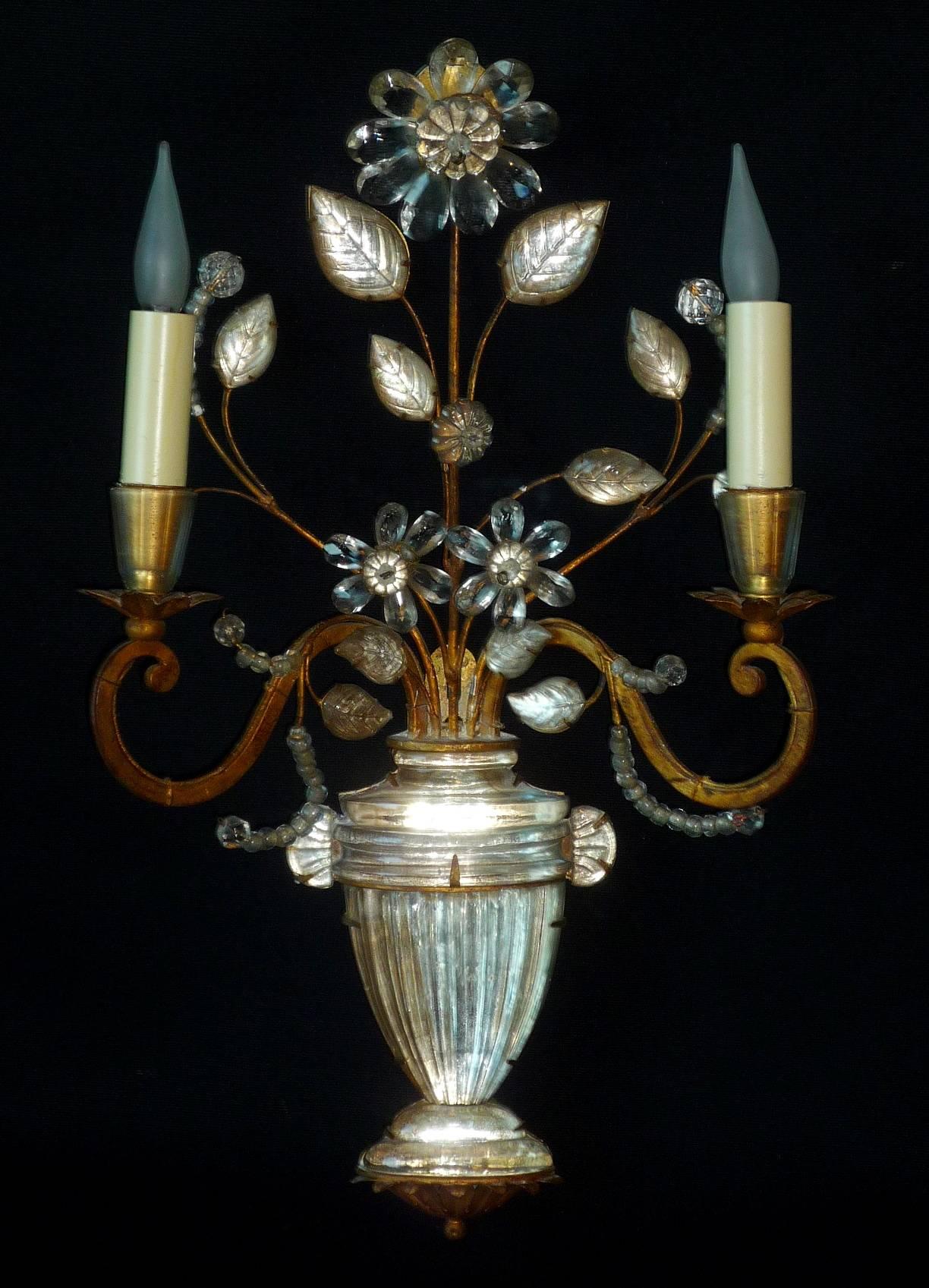 A pair of French Art Deco gilt iron and crystal wall lights (sconces) with neoclassical vases by Maison Baguès, Paris, circa 1925-1930.