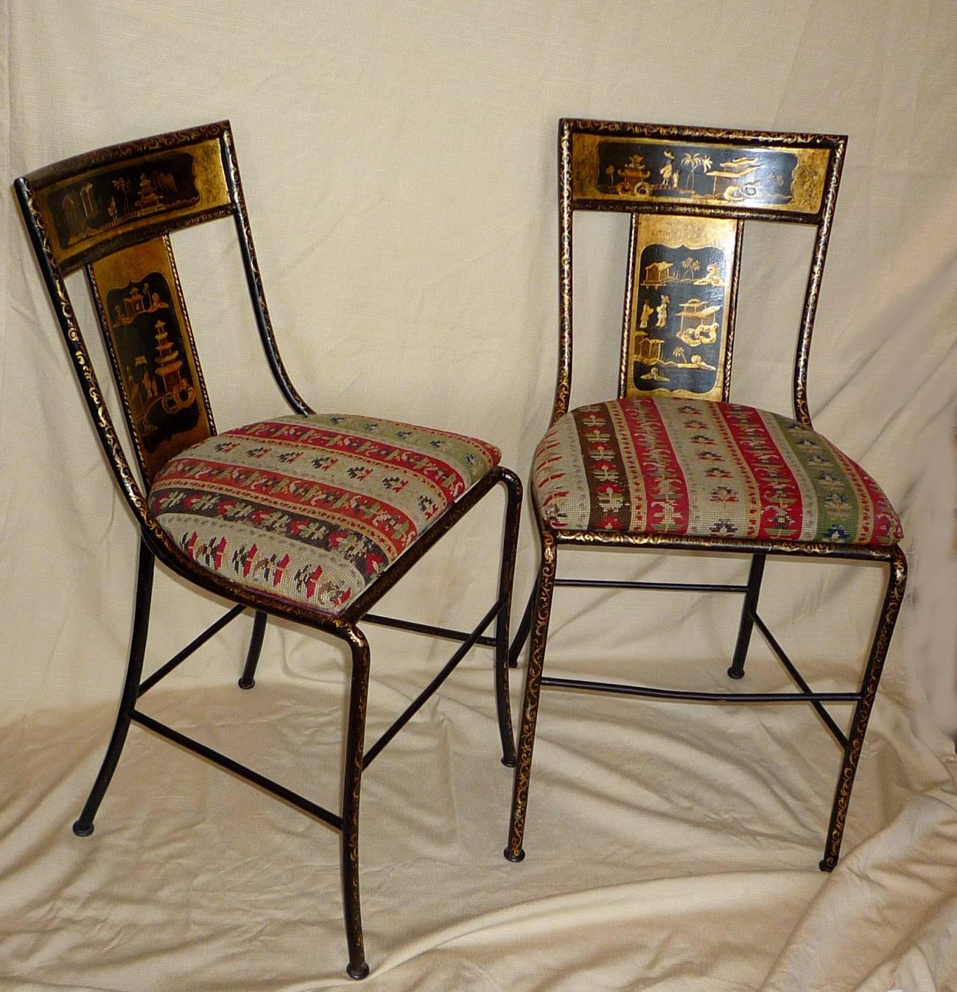 A pair of English Victorian period painted iron chairs, with chinoiserie gold and black decoration, the seats with original needlepoint covers. Provenance: Madeleine Castaing.
 