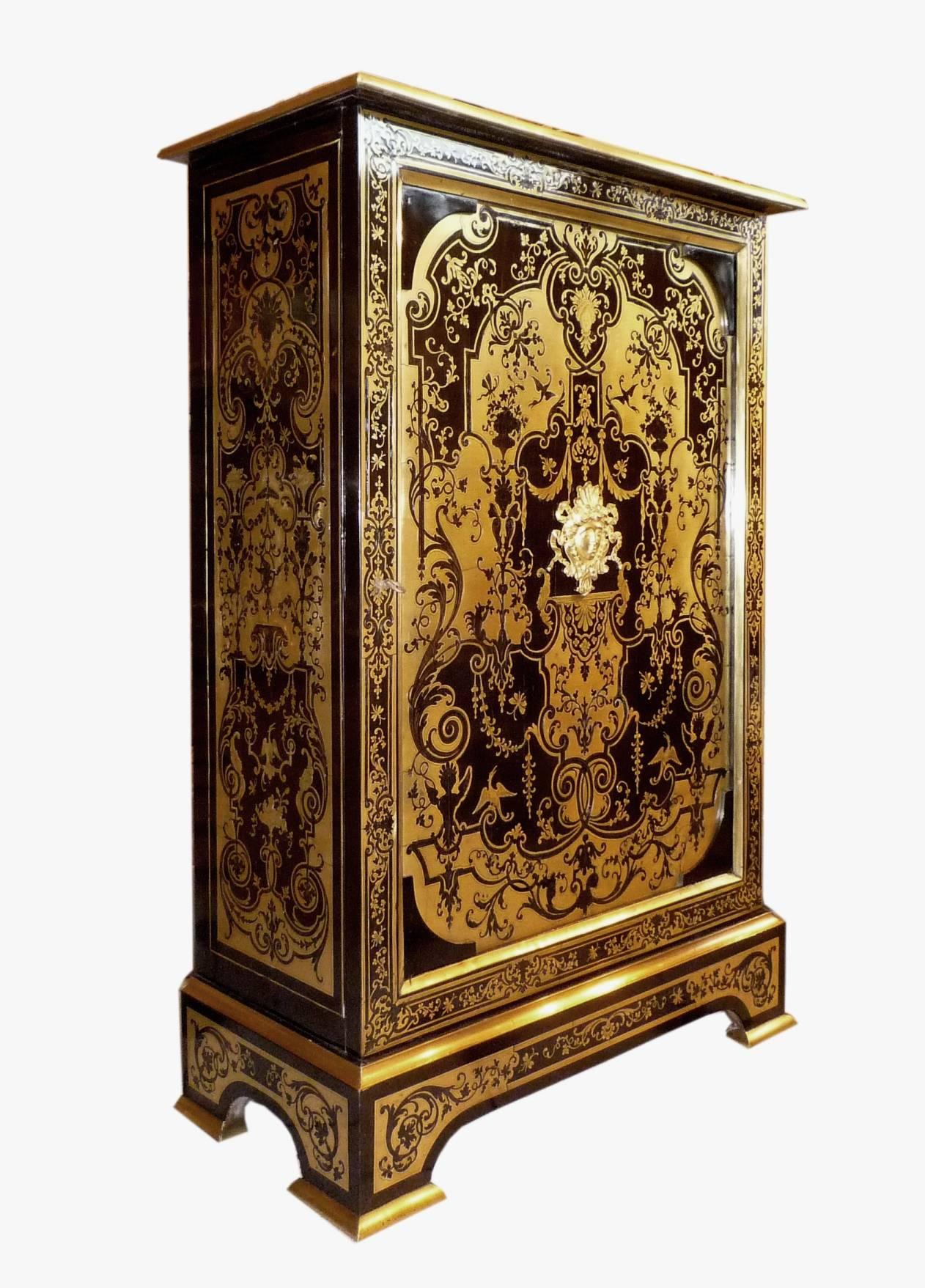 A French Louis XIV style Boulle marquetry on ebony cabinet, with one door, the panels with Berain decoration 17th century, remounted in the second half of the 19th century.