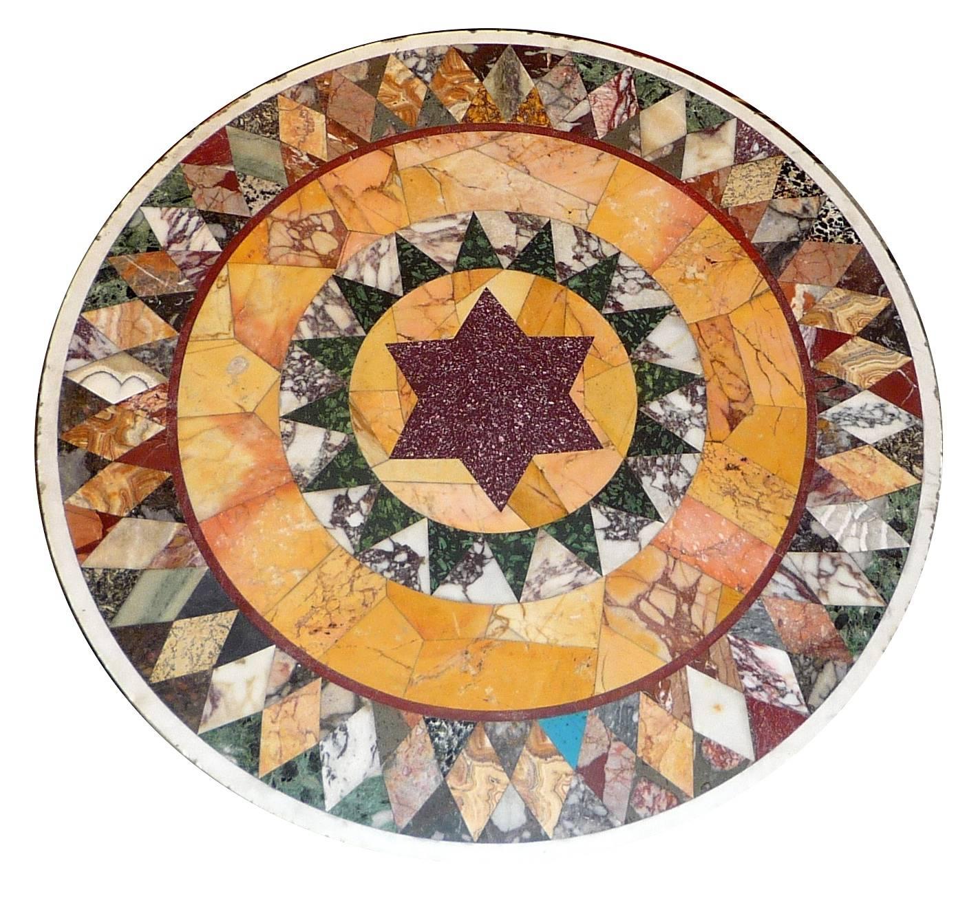 A French 1950s bronze gueridon table supporting an Italian (Roman) marble top with a porphyry star in the middle, circa 1830 (small chips to the rim).