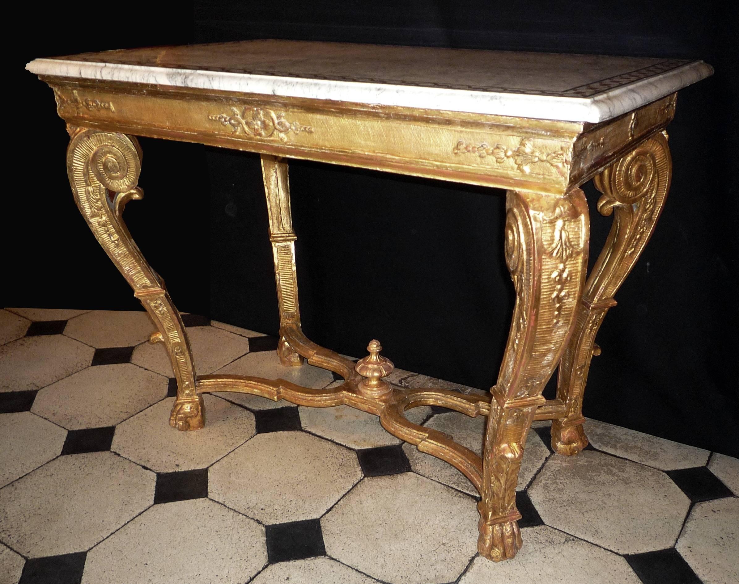 A fine French Louis XV carved and giltwood center table, with a 19th century marquetry marble top. May be originally a console table.