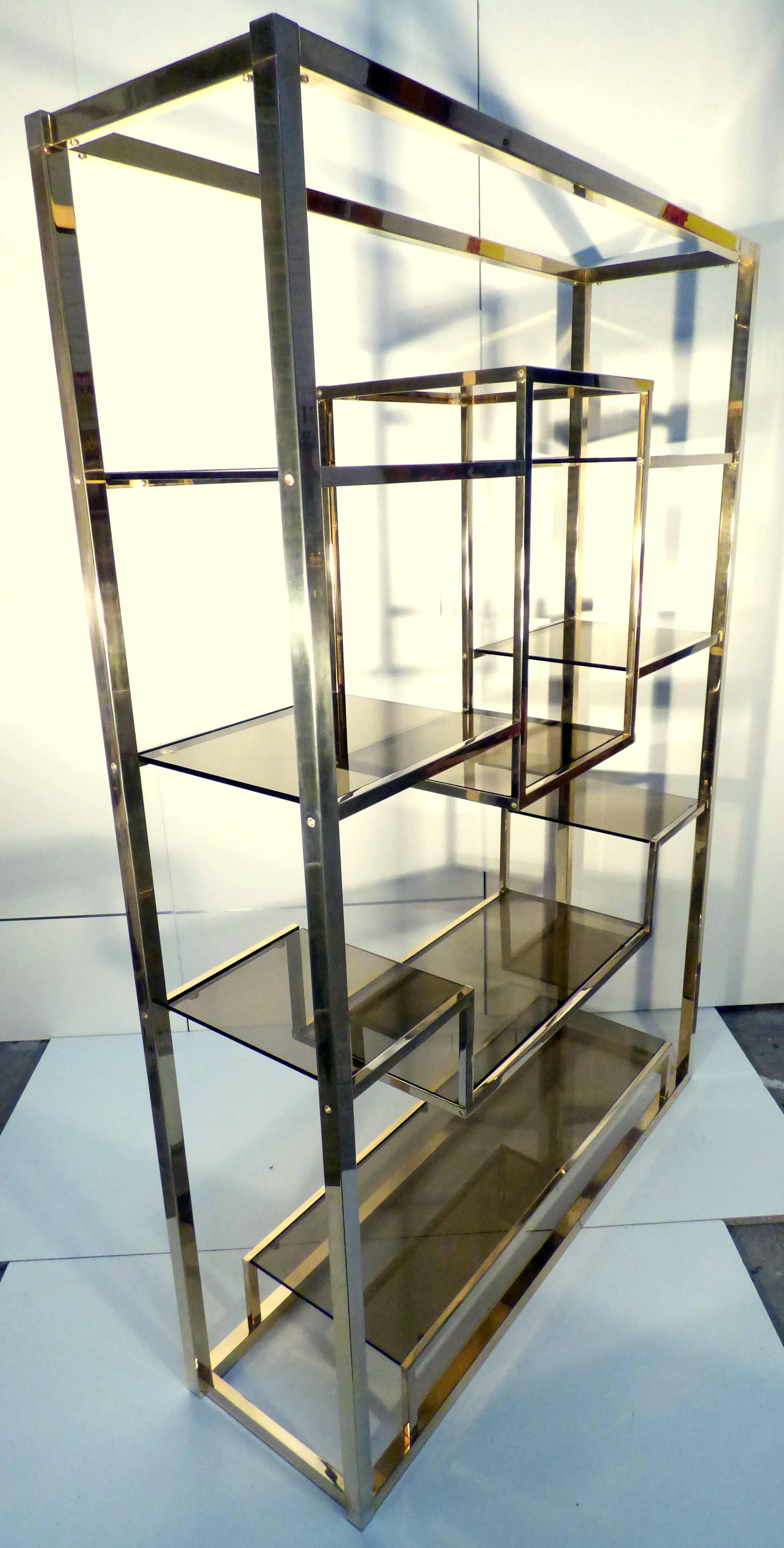Very unique spatial shelf by Romeo Rega made of solid polished brass shelving structure with smoked glass shelves. Will work perfectly as a floating room divider. The whole item is in excellent condition.

For shipping costs, just send us a short