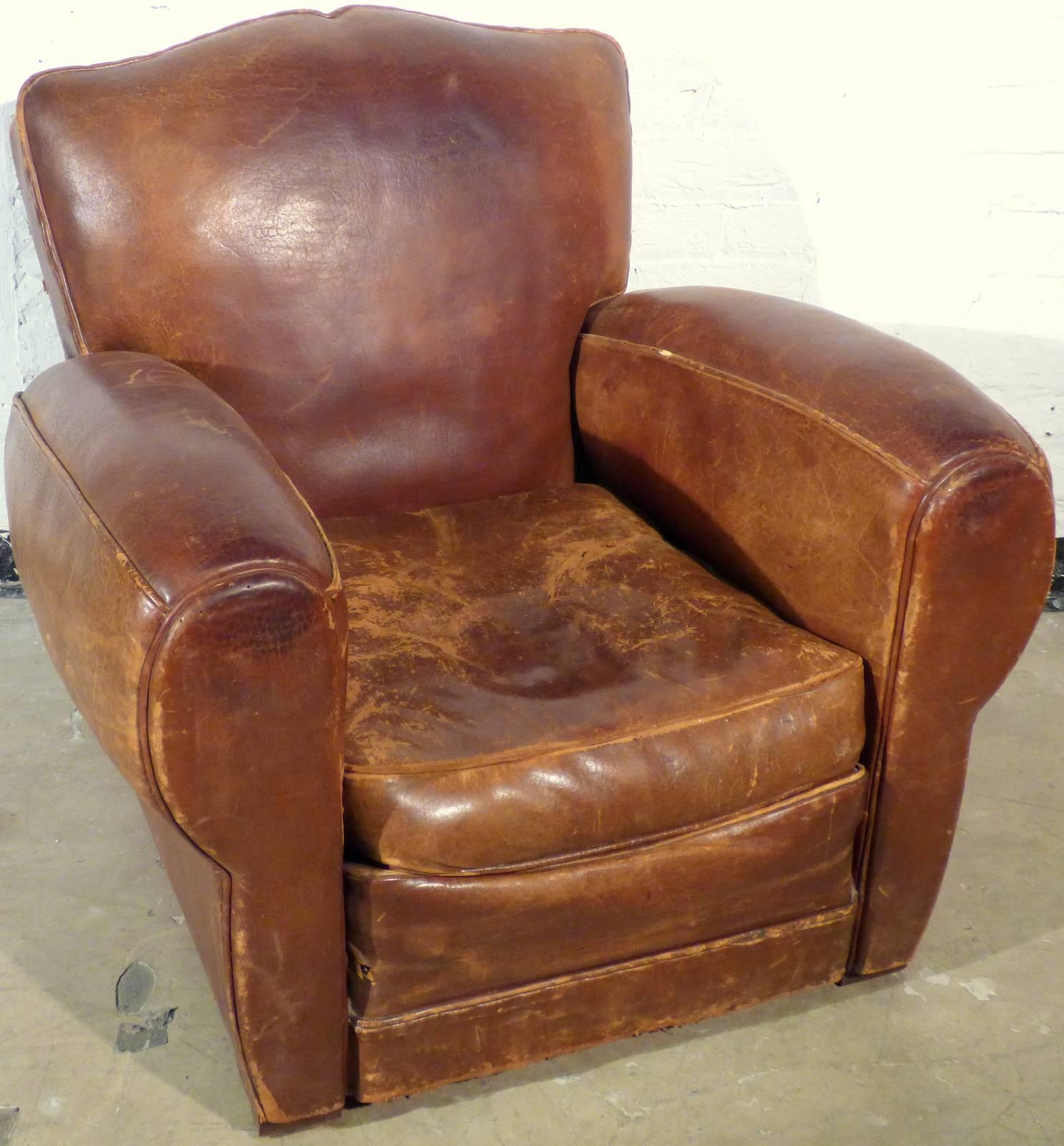 Original club chair from France in good vintage condition. The leather is bold and not porous. All in all, a fantastic patina. 
The seating pad has small (2-3cm) scratch, which can be fixed upon request. We didn't fix it yet due to the individual