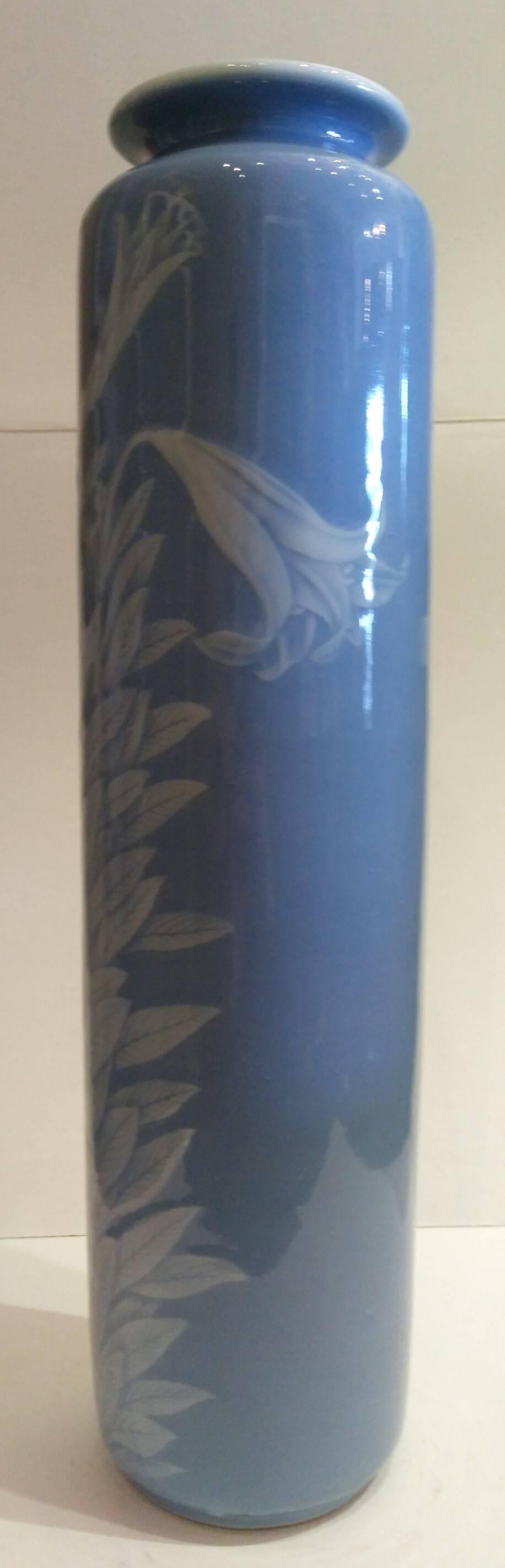 Celadon vase by Miyanaga Tozan. A pale blue slender with a white slip lillies decoration. Seal mark of Tozan.