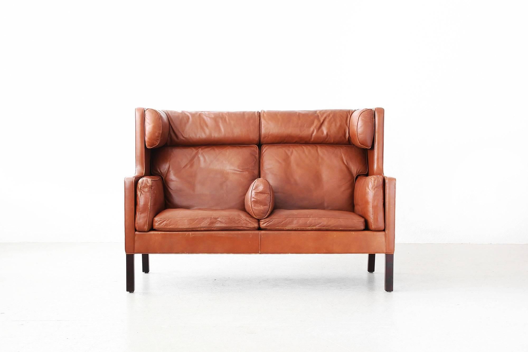 Beautiful "Coupe" sofa by Børge Mogensen for Fredericia.
The sofa is in a very good condition with just little signs of use. The cushions are made of brown leather and are filled with down feathers. Labeled with "Fredericia