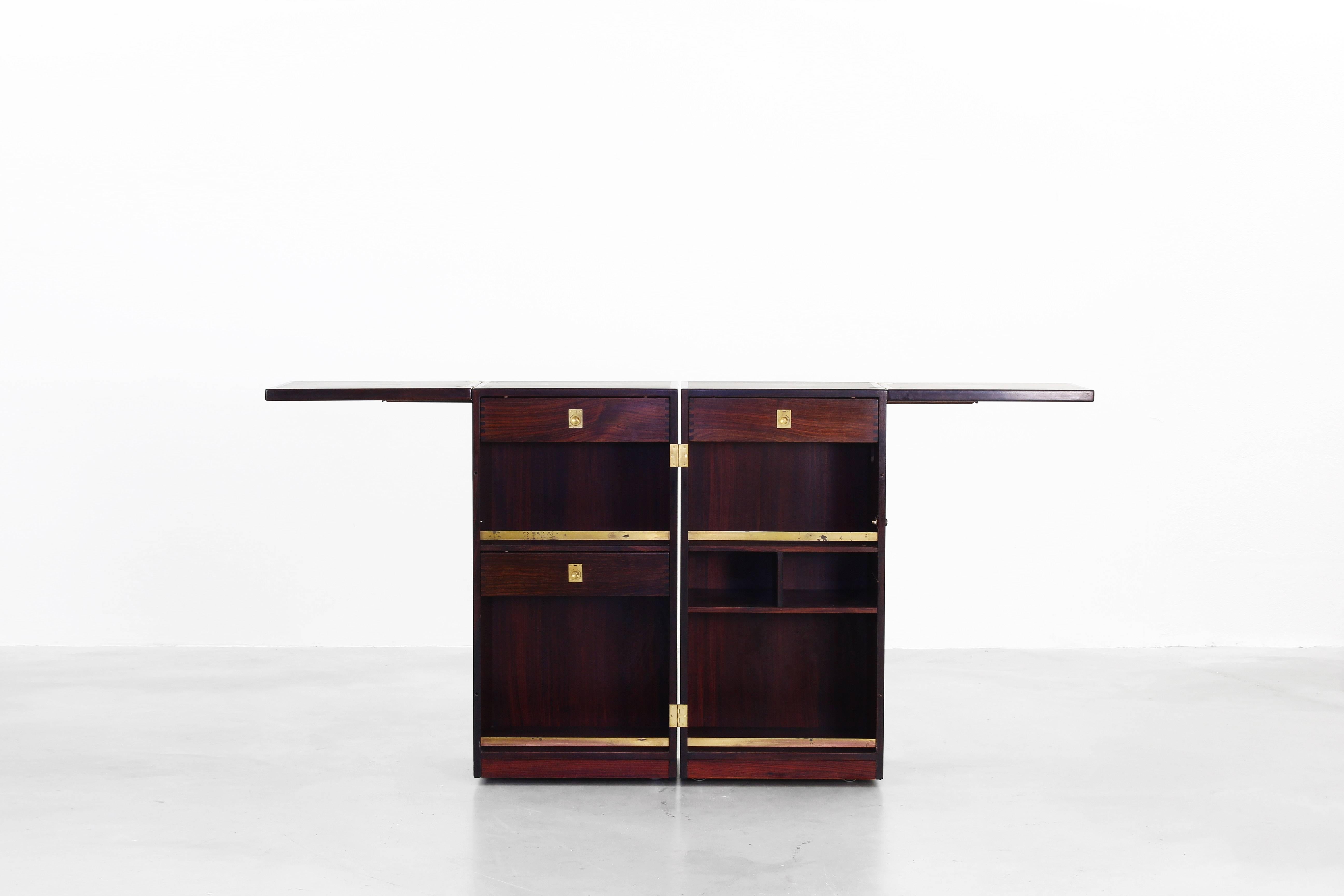 Very beautiful captains bar designed by Reno Wahl Iversen and manufactured by Dyrlund, Denmark in the 1950s. The bar is made of rosewood and brass elements and is a very good condition with just little traces of usage.