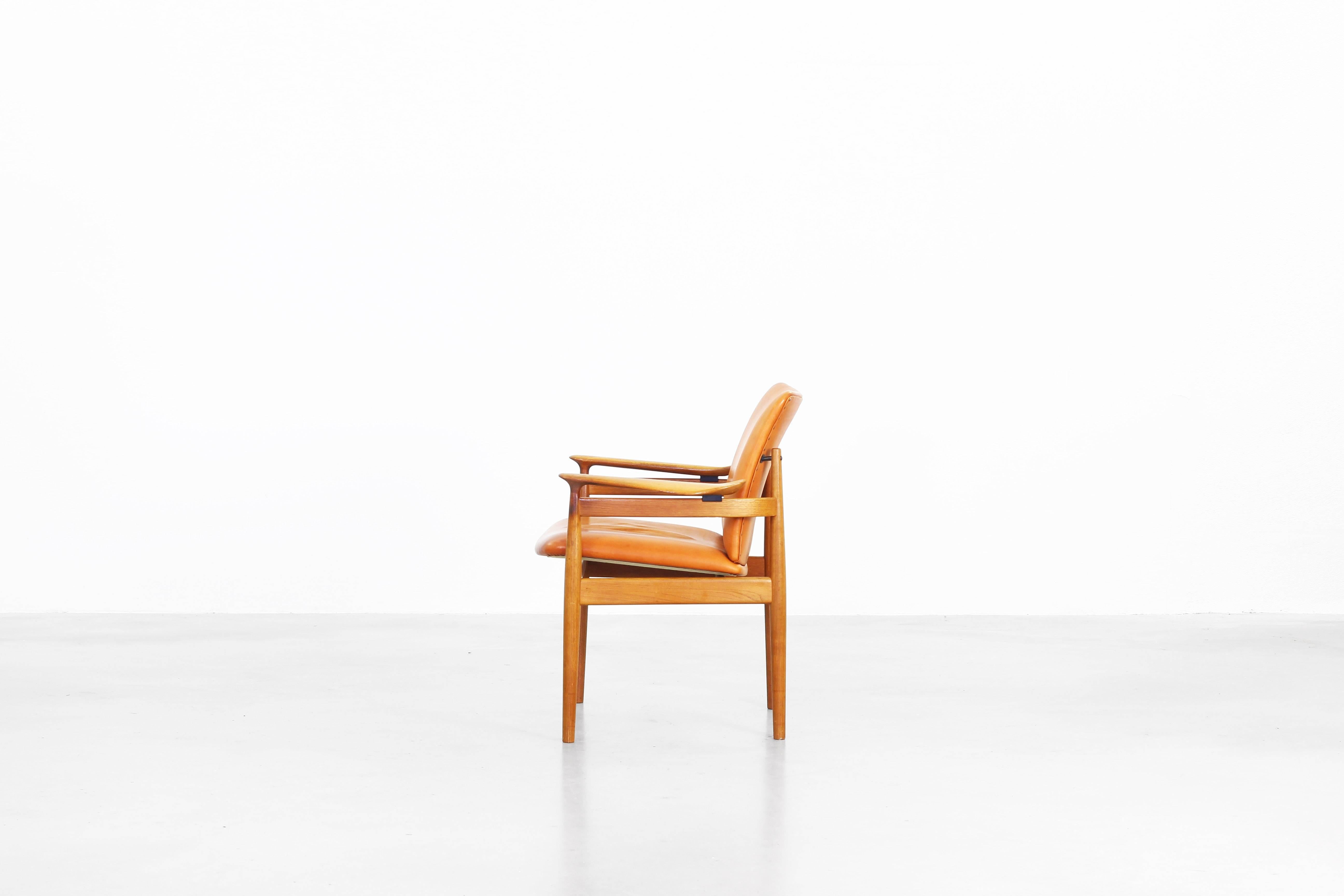 Very beautiful armchair designed by Finn Juhl for France and Daverkosen in 1963, made in Denmark. The armchair comes with a beautifully patinated brown-cognac leather and the frame is made of teak wood. Still in an original condition, labelled on