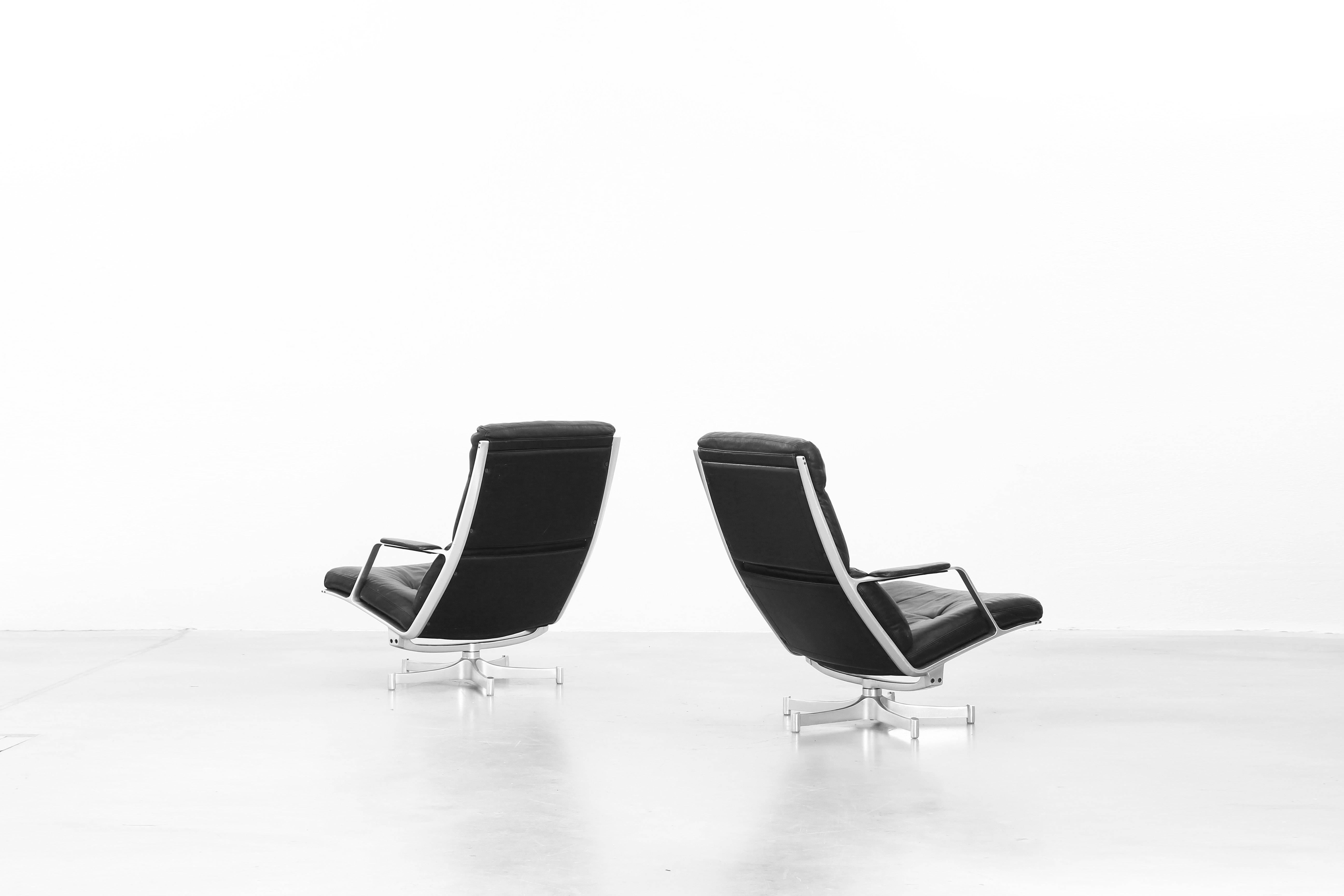 A pair of beautiful lounge chairs with two Ottoman by Preben Fabricius and Jørgen Kastholm for Kill International, designed in 1968, made in Germany. The lounge chairs are in a very good condition with just little signs of use. One stool is with