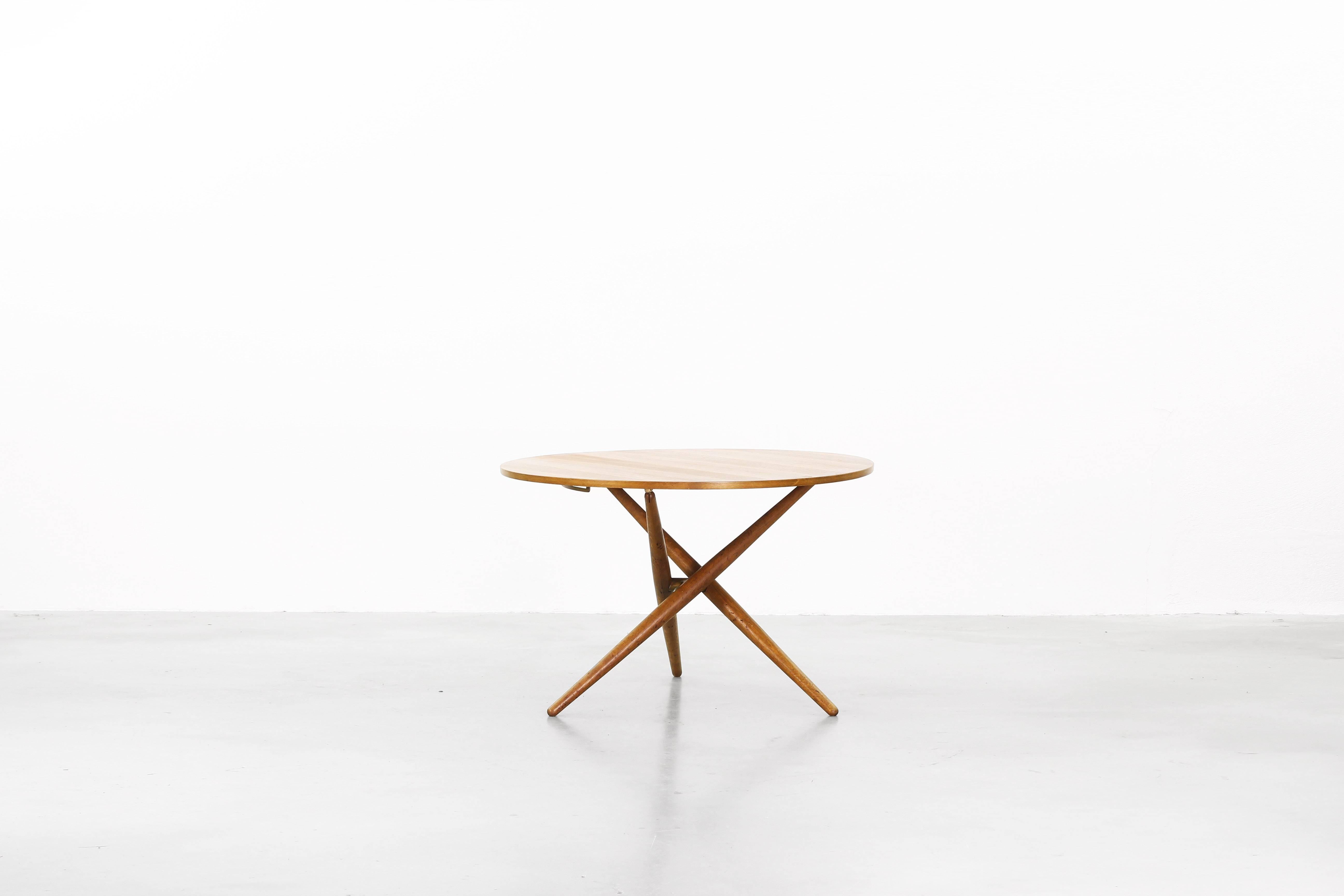 Very beautiful height adjustable dining/coffee table designed by Jürg Bally for Wohnbedarf, Zürich, Switzerland in the 1950ies. The table is made of teak and brass elements and is in a very good condition. There is one professionally repaired veneer