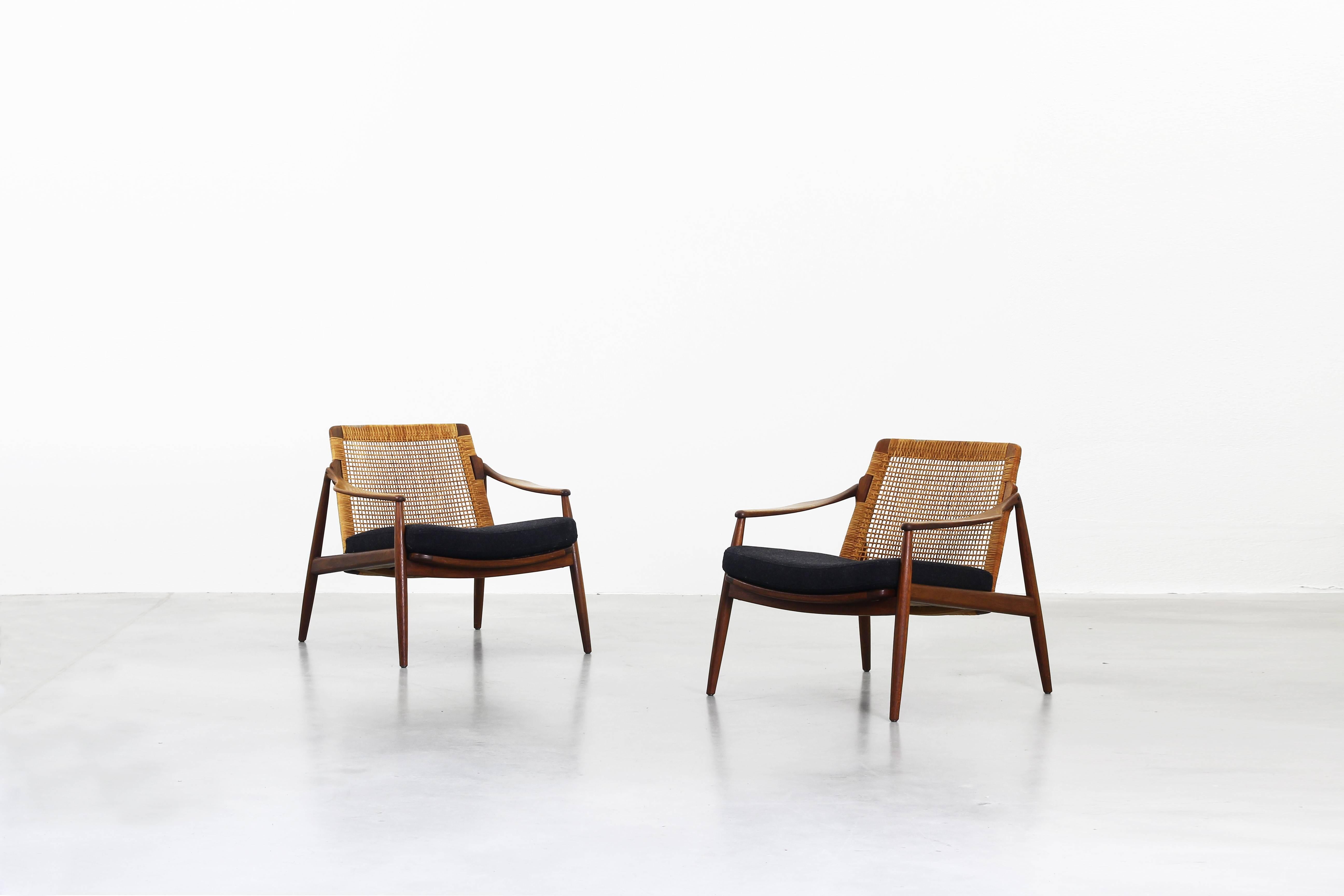 Very beautiful lounge chairs designed by Hartmut Lohmeyer for Wilkhahn in the 1950s, made in Germany. Very beautifully shaped, newly reupholstered with a high quality fabric by Kvadrat in dark grey, the cane and the teak wood frame are in an