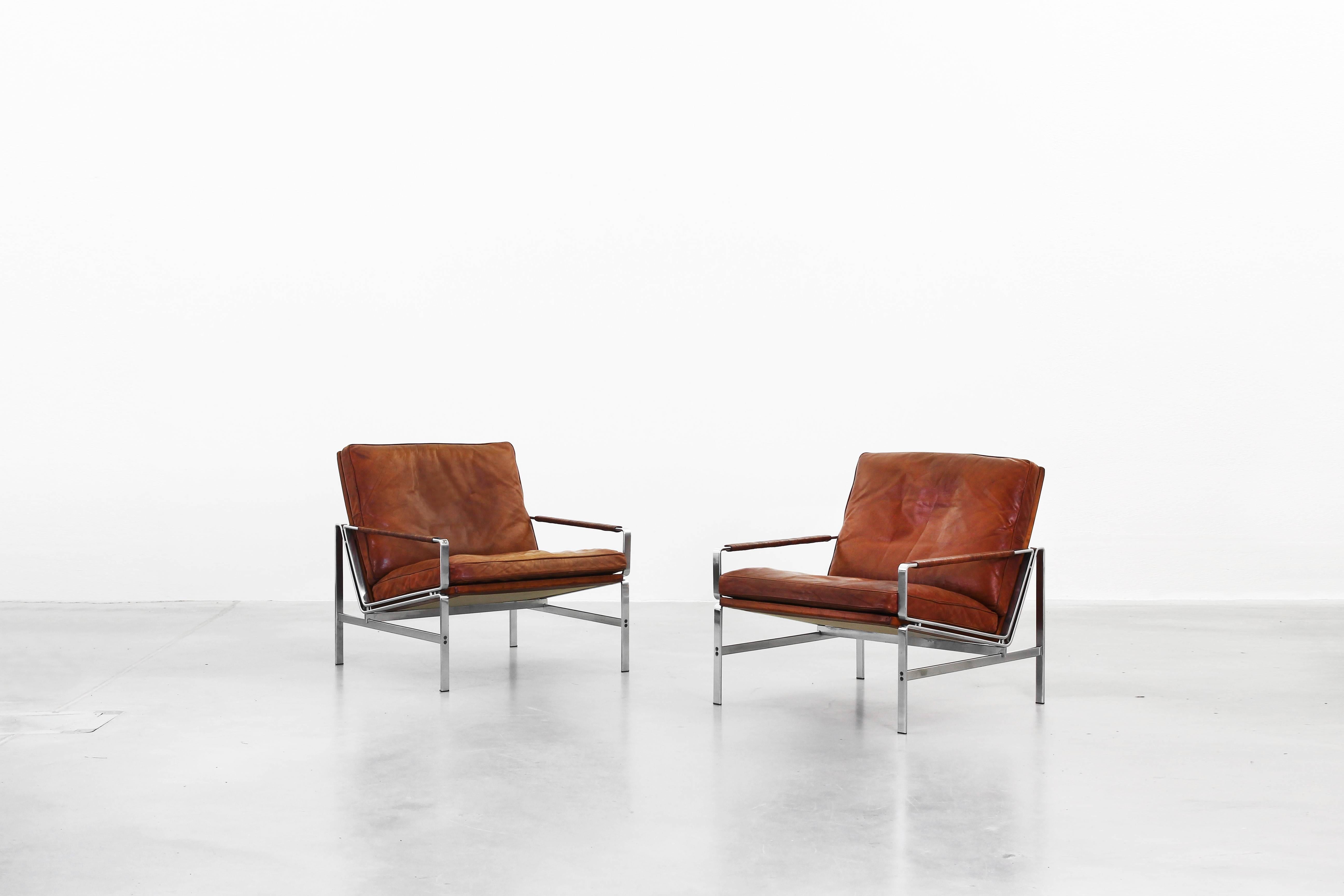 A beautiful pair of lounge chairs designed by Fabricius & Kastholm for Kill International in 1968. Both lounge chairs are in a very good condition with little signs of use. The leather in brown- cognac is with a fantastic patina and the chromed