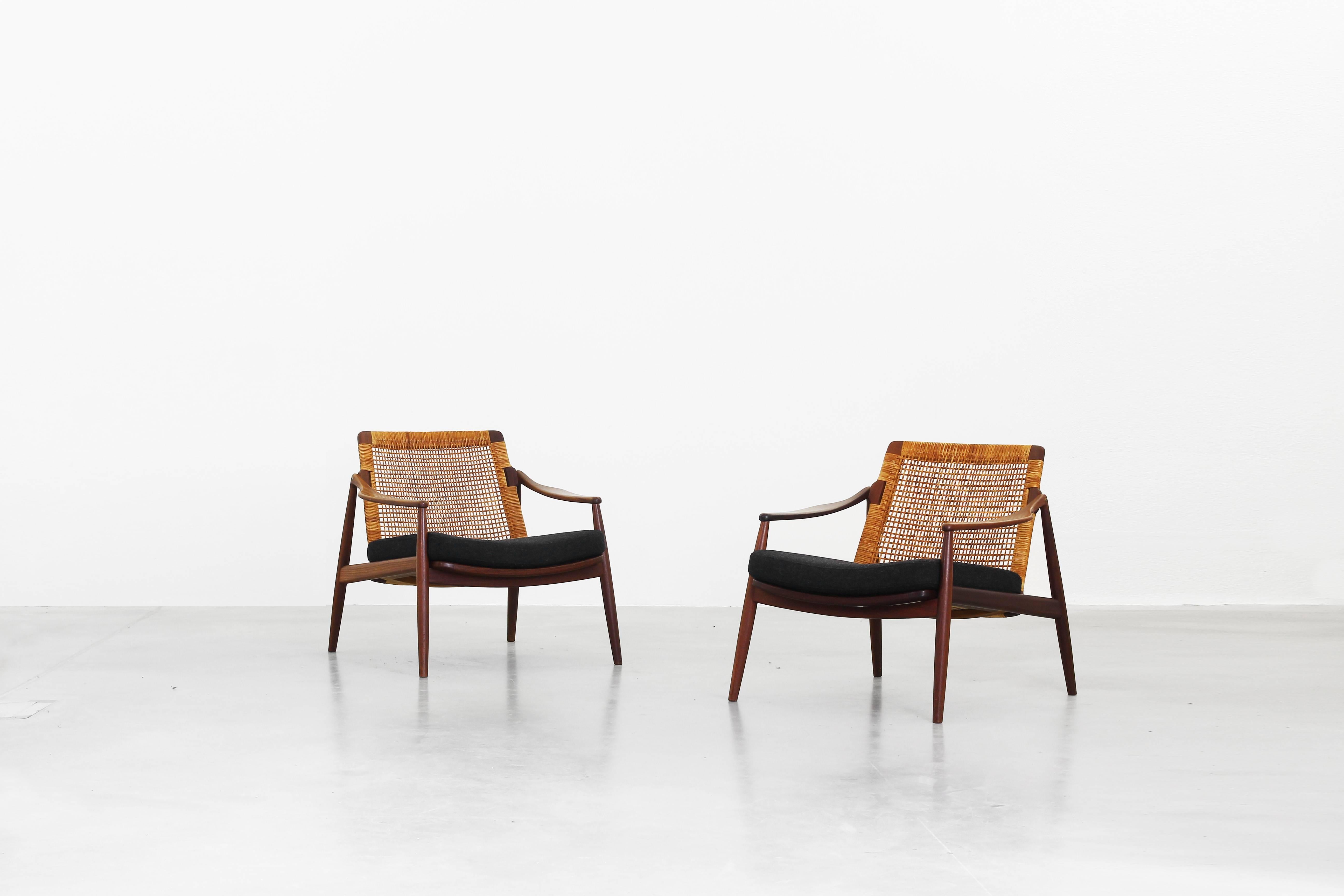 Very beautiful lounge chairs designed by Hartmut Lohmeyer for Wilkhahn in the 1950s, made in Germany. Very beautifully shaped, newly reupholstered with a high quality fabric by Kvadrat in dark grey, the cane and the teakwood frame are in an