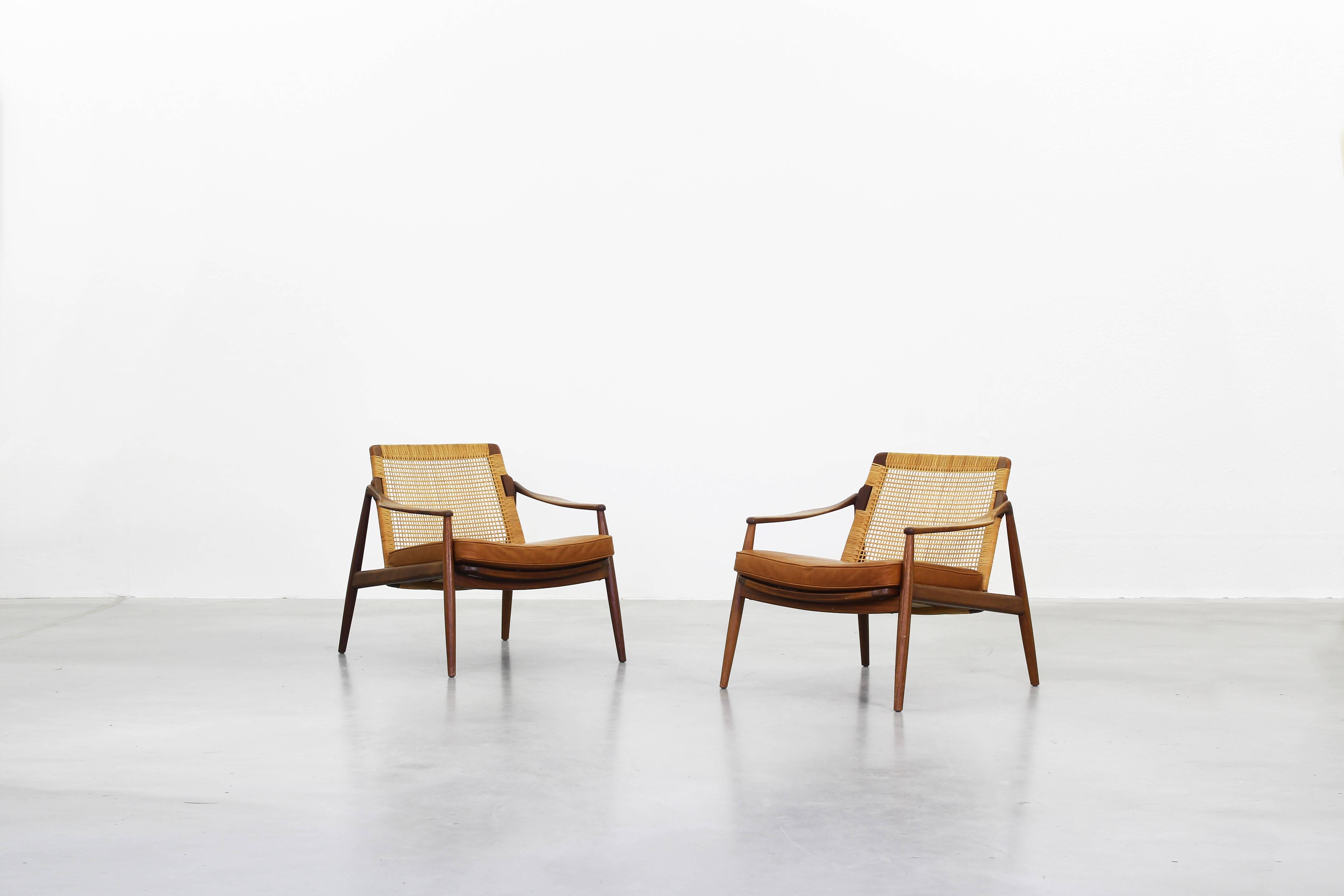 Very beautiful lounge chairs designed by Hartmut Lohmeyer for Wilkhahn in the 1950s, made in Germany. Very beautifully shaped, brown-cognac leather, the cane and the teakwood frame are in an excellent condition.