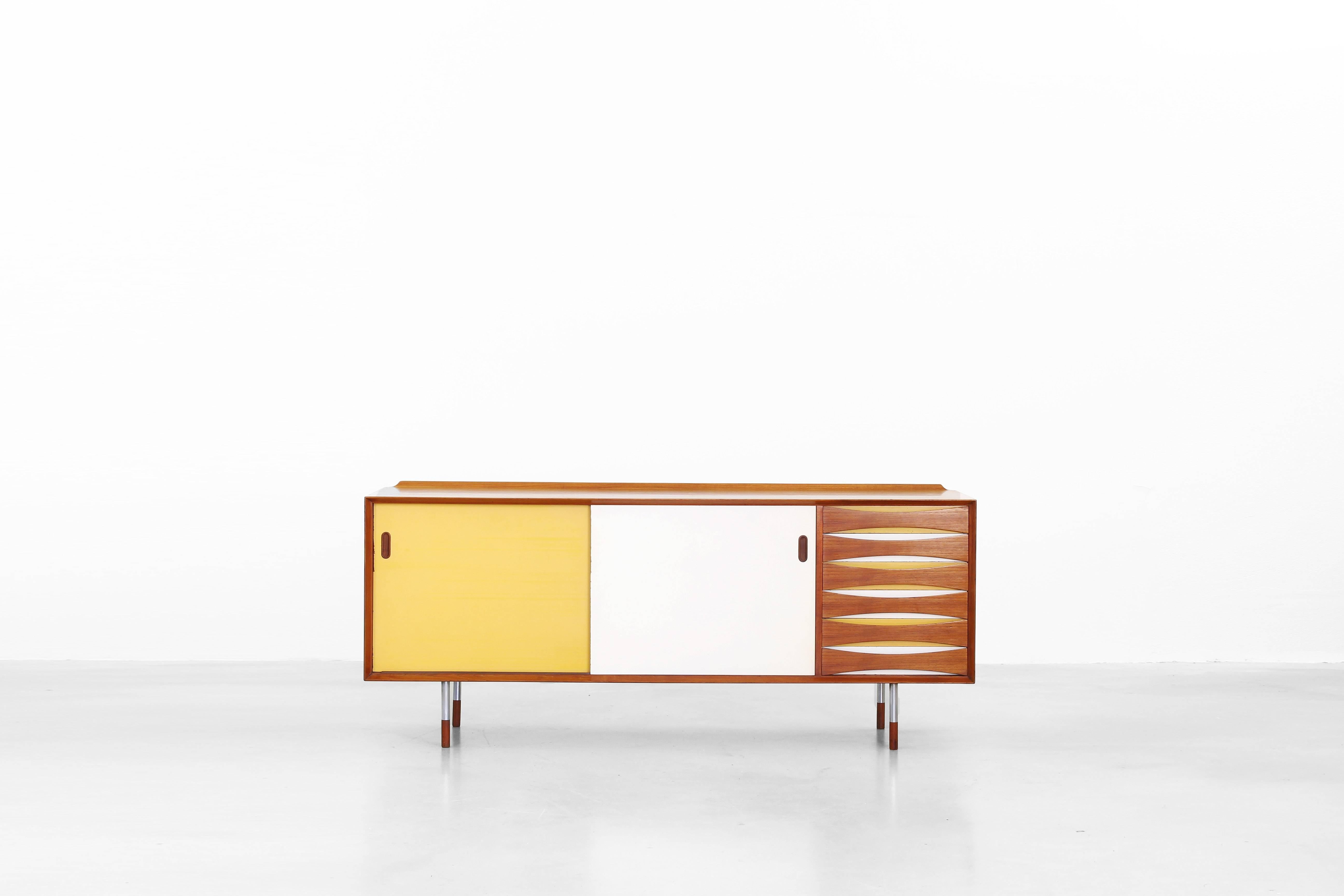Very beautiful sideboard mod. 29 designed by Arne Vodder for Sibast Furniture, Denmark in 1958. Very beautifully made with turn able doors and yellow white lacquer on the drawers. This sideboard is made of teak and is still in a very good original