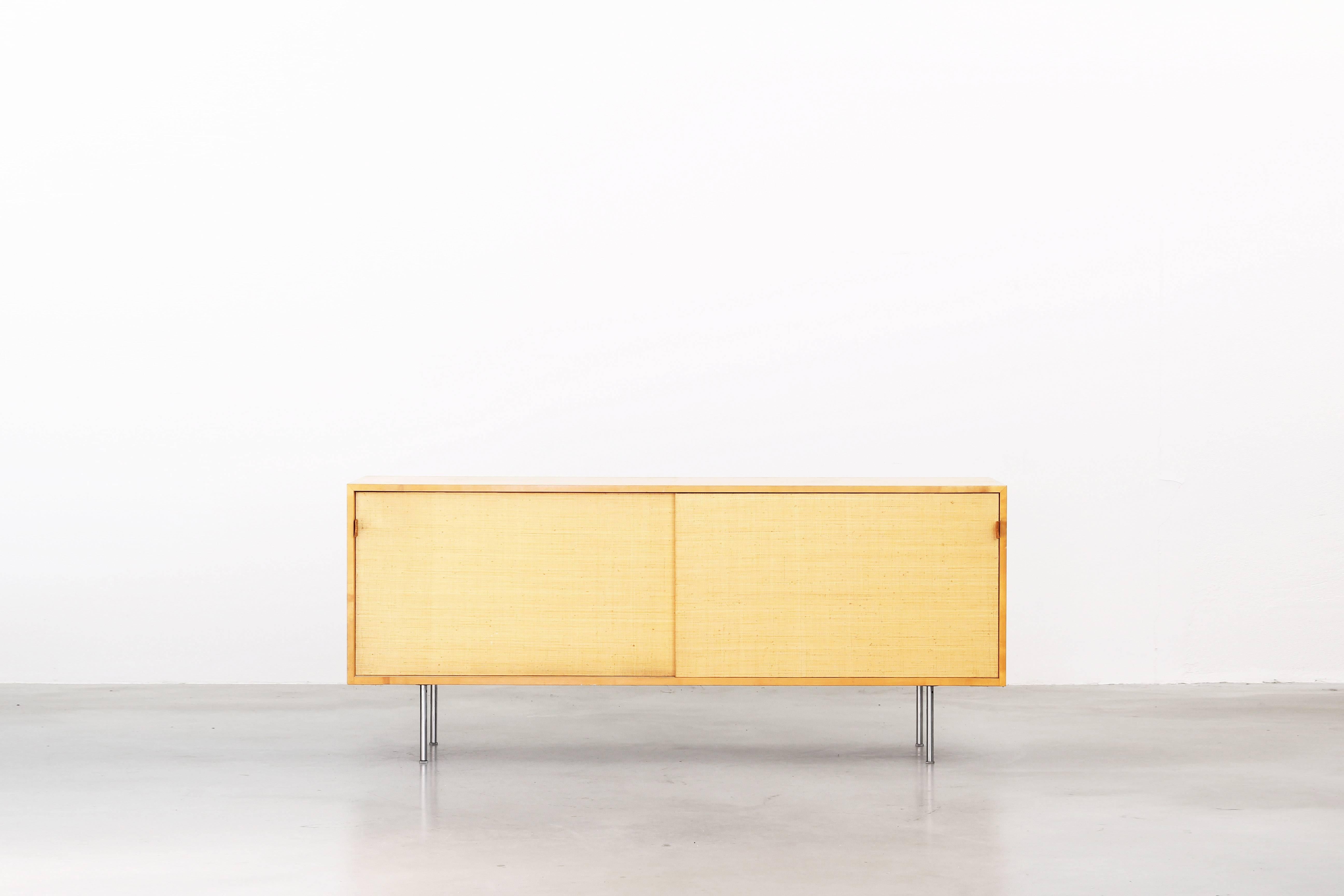 Very beautiful sideboard designed by Florence Knoll for Knoll International in the 1950s.
It is made of pear tree wood, cane and leather and still in a wonderful condition with just little traces of usage.
