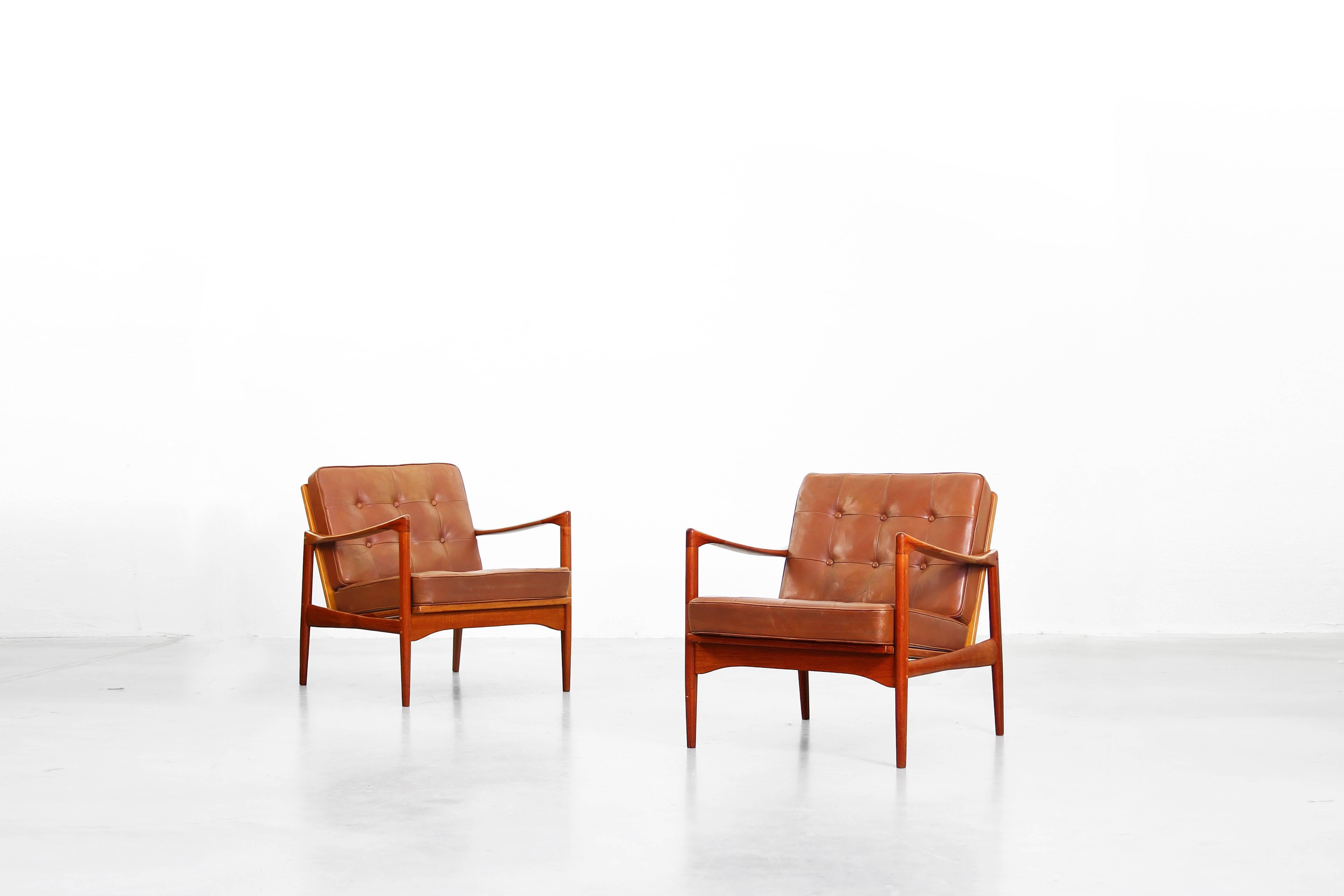A beautiful pair of Lounge Chairs designed by Ib Kofod Larsen and produces by OPE Sweden in the 1960ies.
The chairs are made of teak and the cushions are covered with brown leather (original), very good condition.