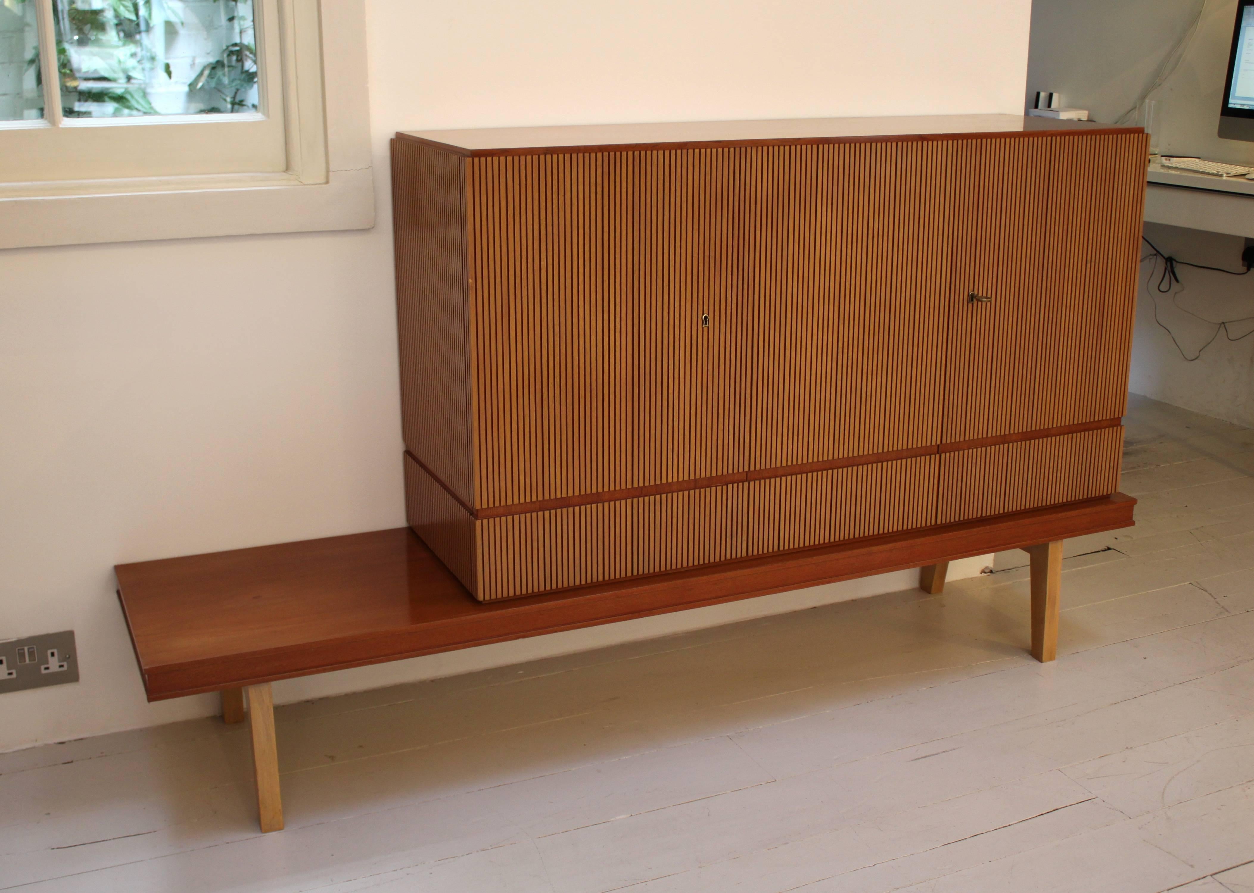 Three-door cabinet on an extended base.

Bleached walnut reeded finish on the doors and sides.

Italian, 1950s