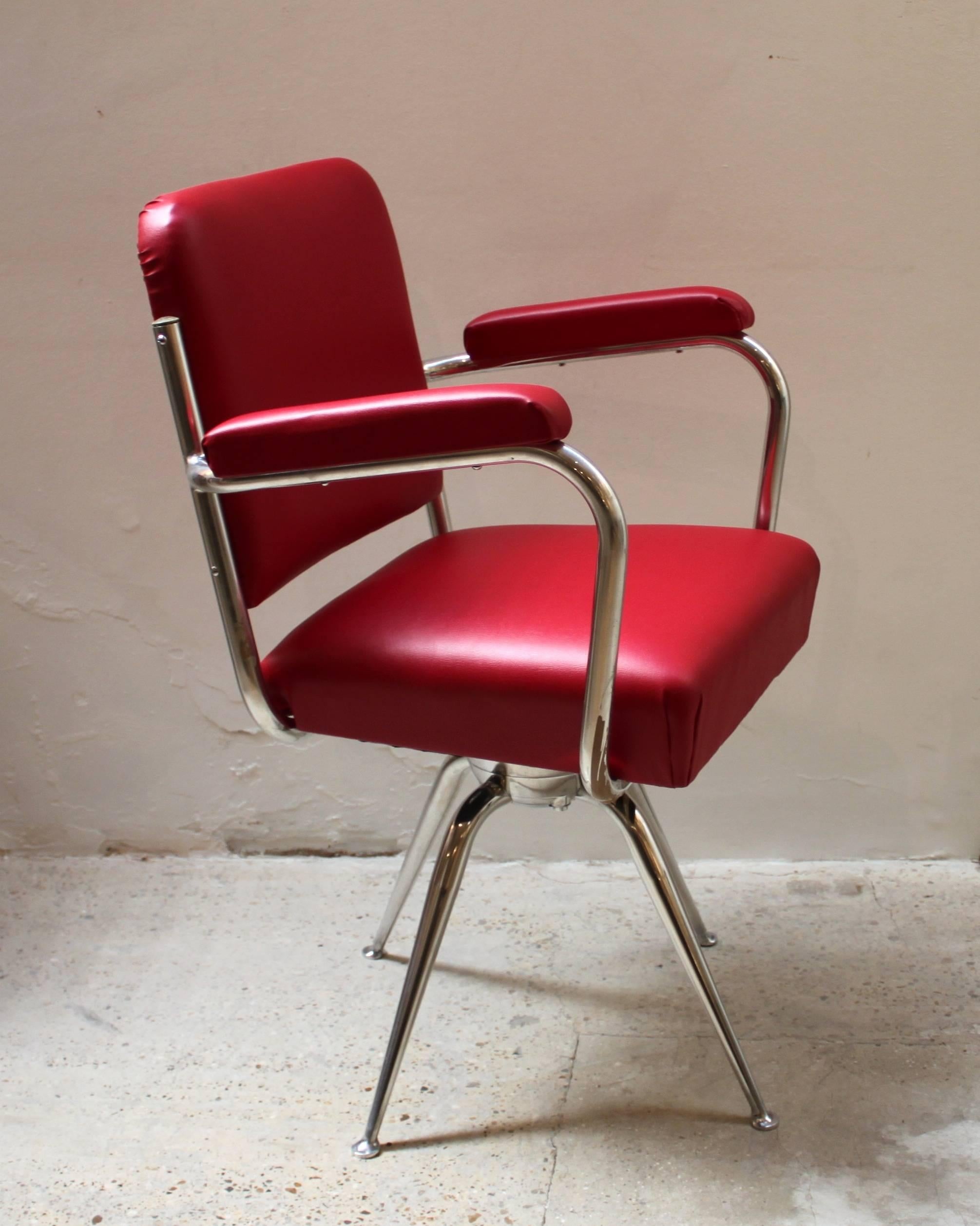 Elegant chrome and red leather desk chair in the style of Gio Ponti.
 