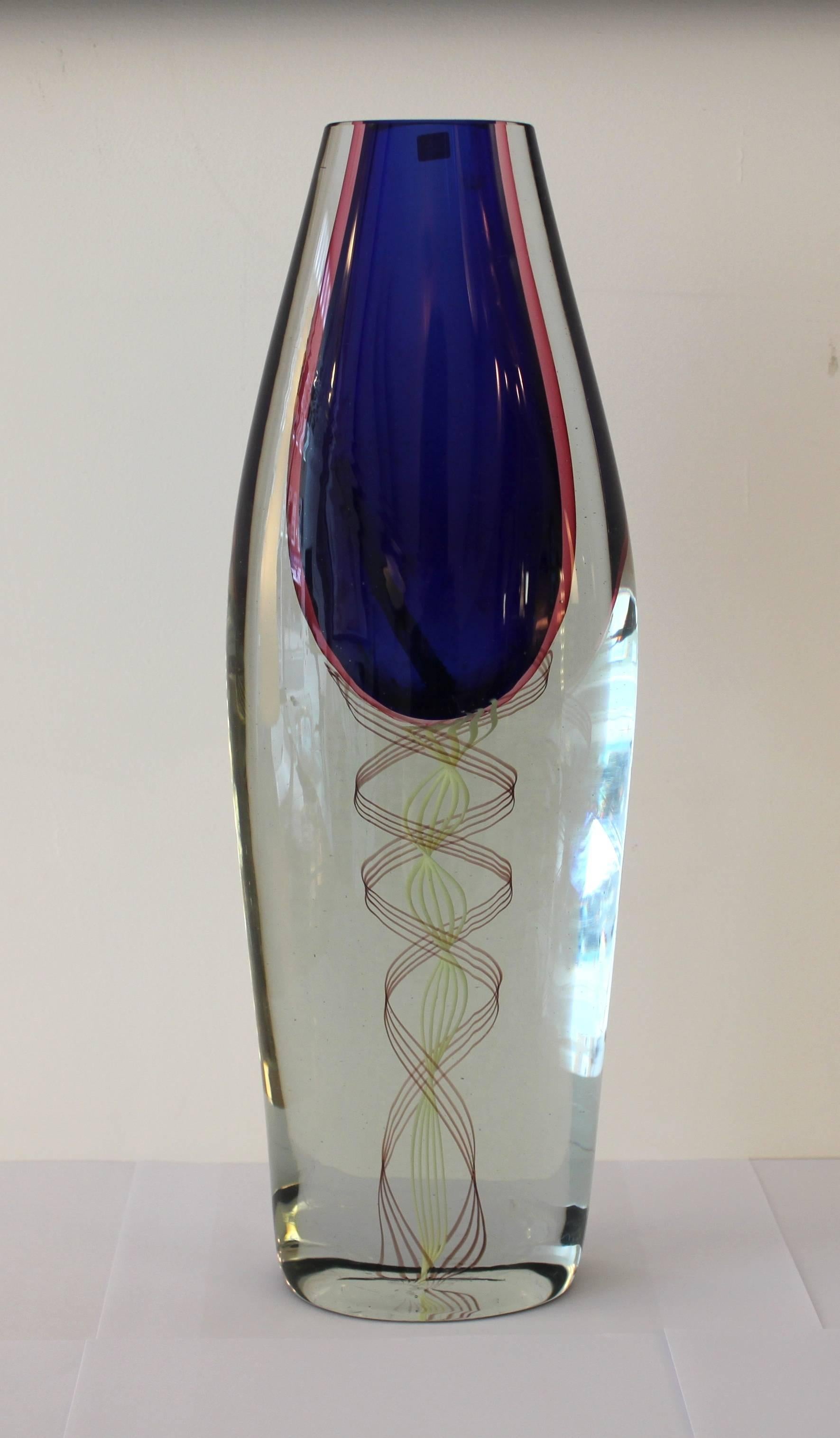 Decorative Sommerso technique vase by Lucio Gaspari for Salviati.

The clear glass vase has a number of three dimensional coloured glass filaments encased in the base with a blue glass encased to form the container. 

Italian, 1960s.