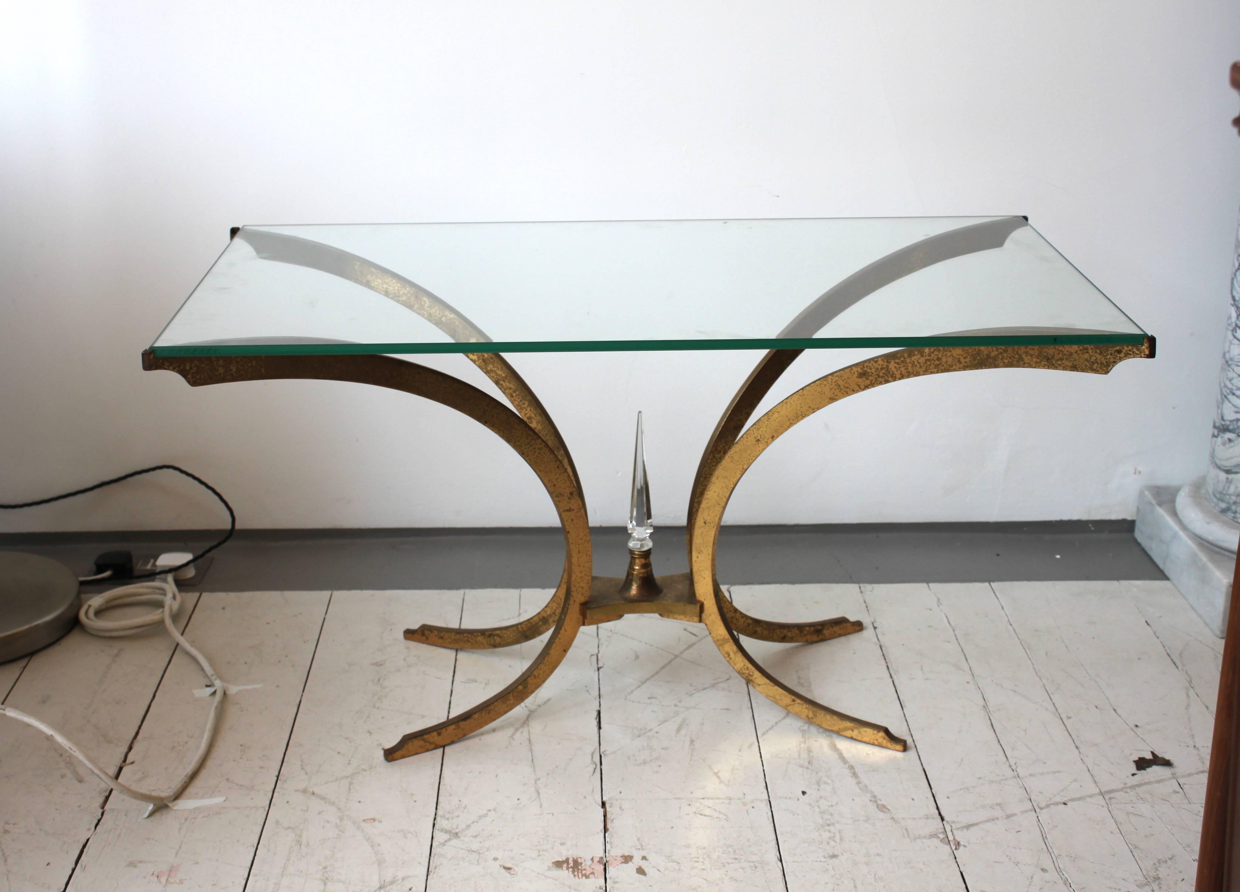 Elegant brass coffee table with glass top.

French, 1950s.