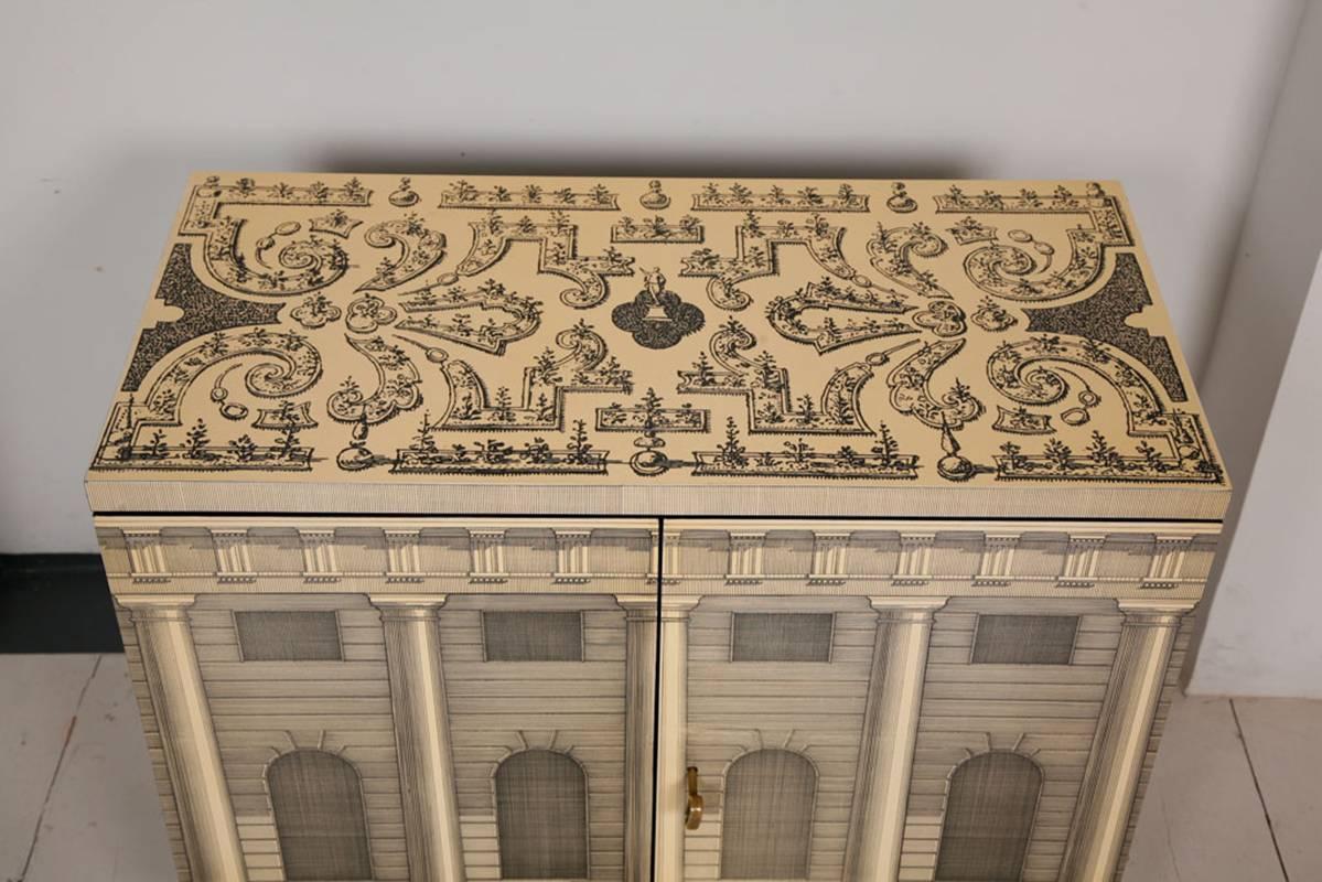 Beautiful small 'Architettura' cabinet designed by Piero Fornasetti.

Labelled inside one of the doors,

Italian, circa 1955.