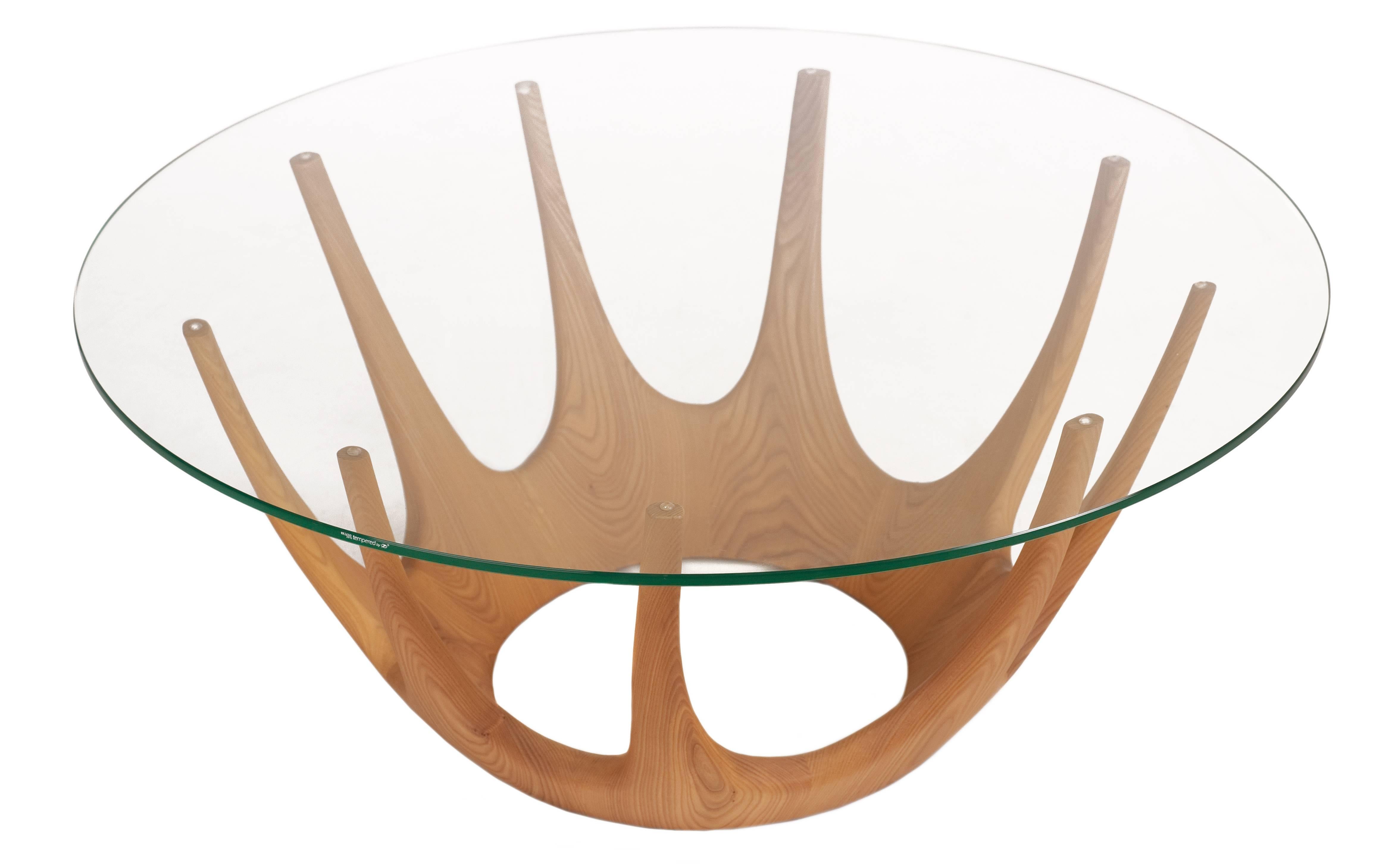 The crown table, as its name suggests, is the personification of a crown. Complex in structure and handmade from beautiful solid ash with tempered glass, it is both robust and incredibly elegant.