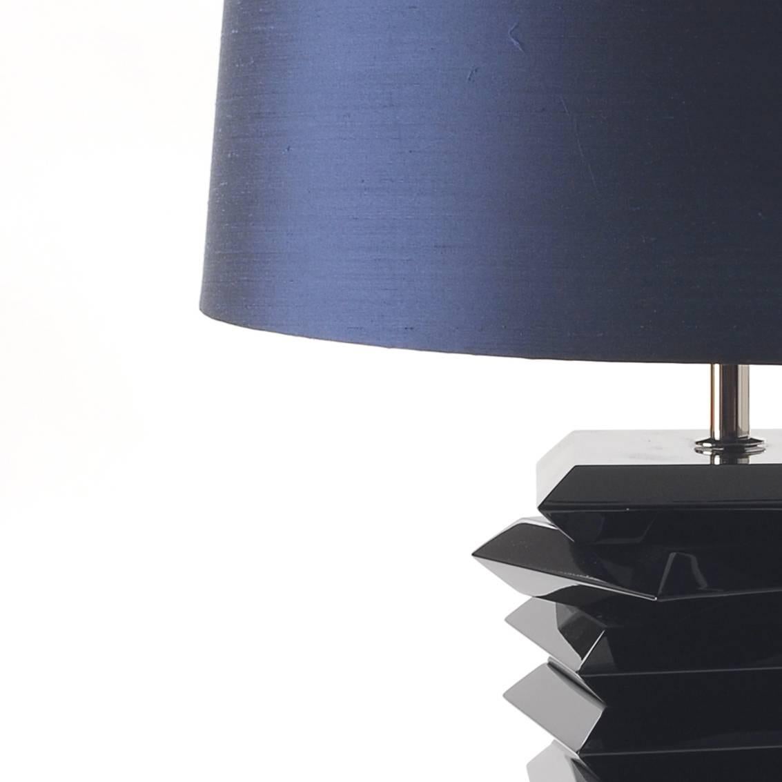 With its geometric form and Classic size, Tribeca desk lamp is the
perfect addition to any modern décor, easily converted from a table
lamp to a bedside lamp. It's masculine character goes along well with
the warm natural coloring of the shade