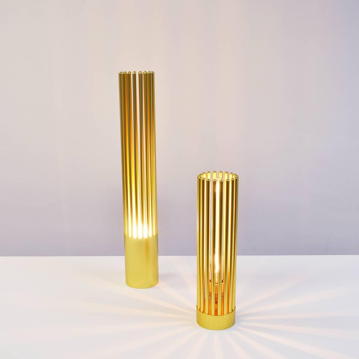 Electra uses a L.E.D golf ball bulb to create a warm uplighter. Electra XL is an opulent desk lamp which references the Art Deco movement with its vertical geometric lines. It combines 26 screw-in arms to create a soft, warm up-glow of light.