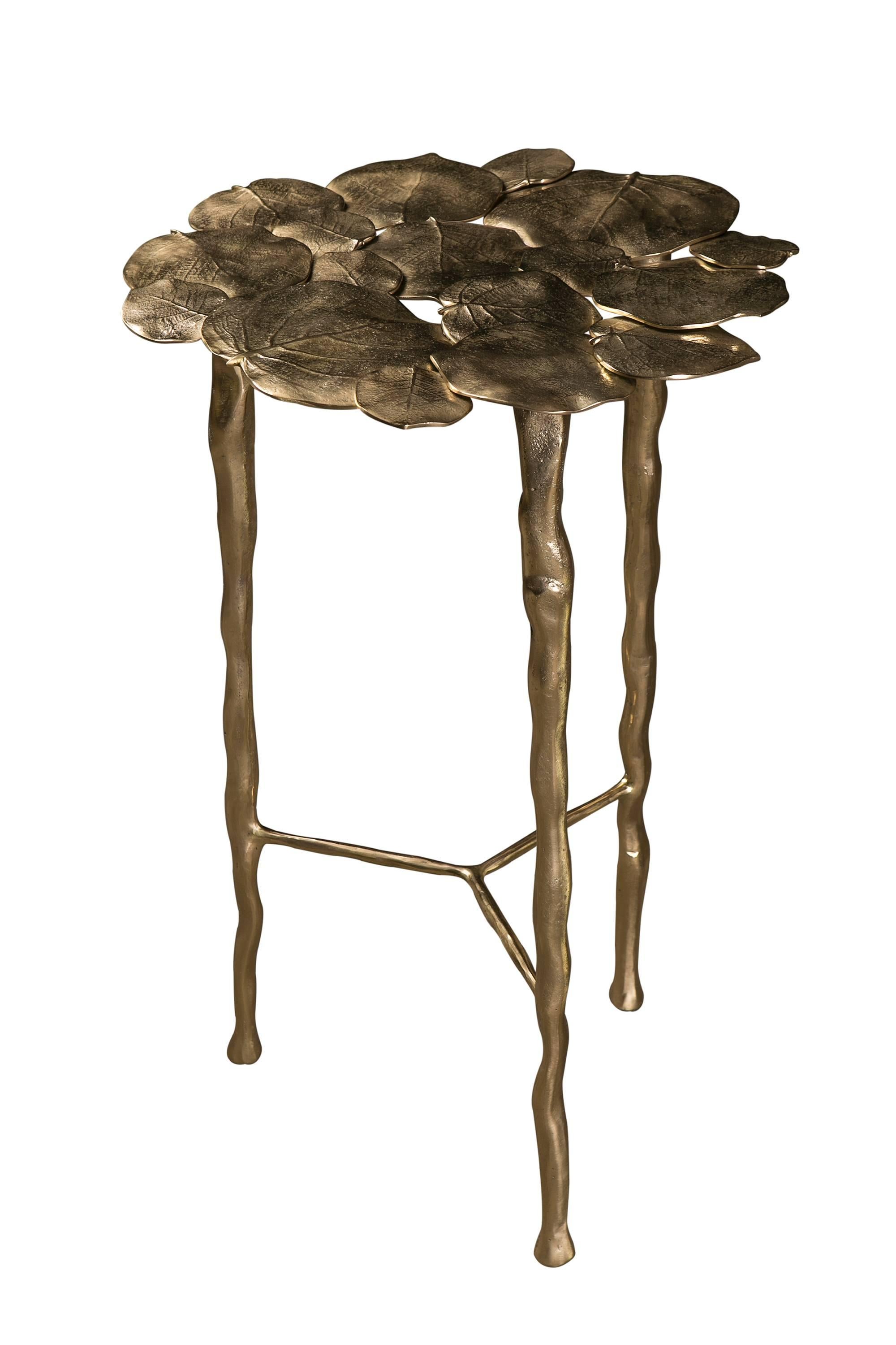 A beautiful decorative side table composed of individually moulded cast brass leaves with brass legs.