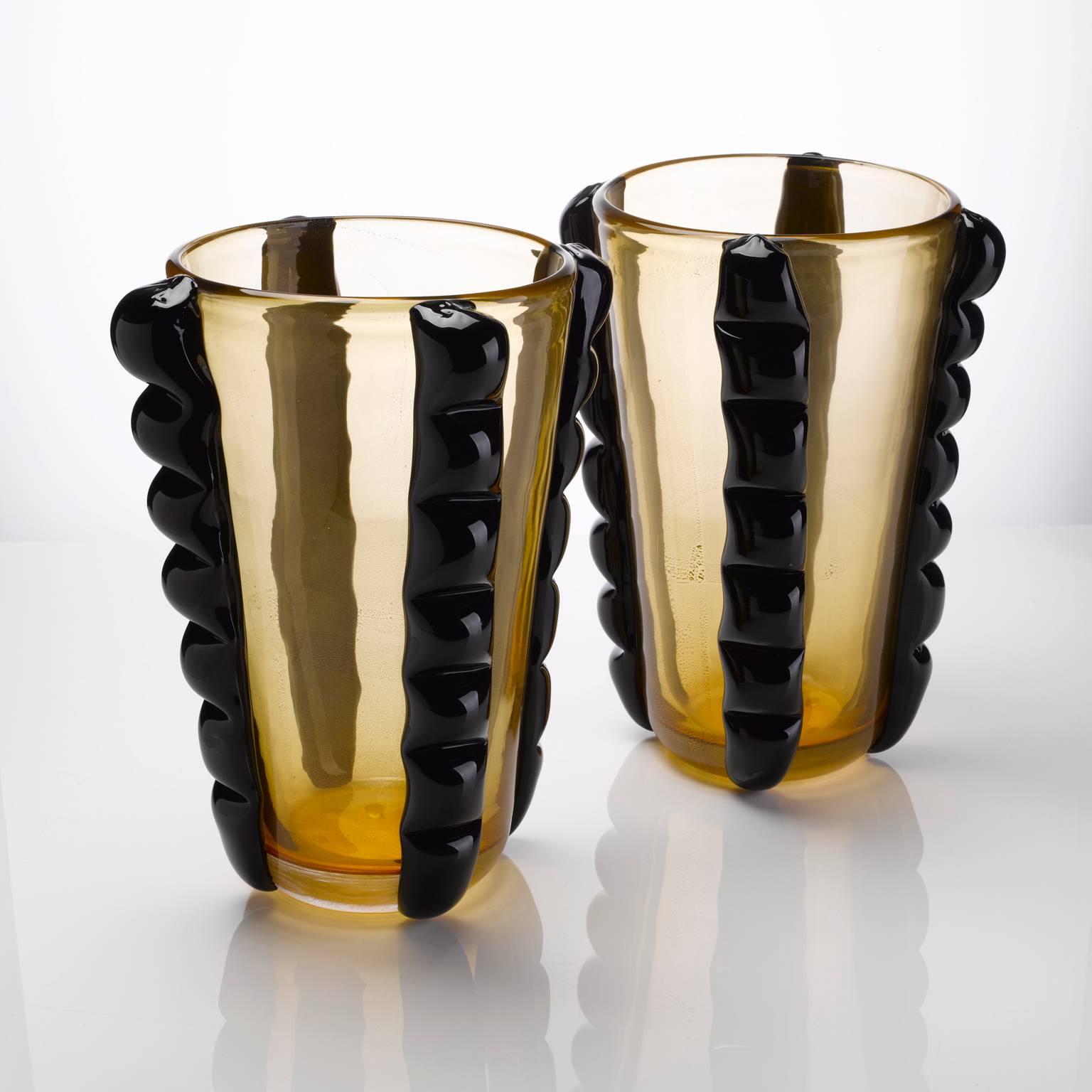 A pair of exquisite Pino Signoretto Murano vases with gold finish to the body and heavy black external detailing.

Signature on the bottom of each vase.