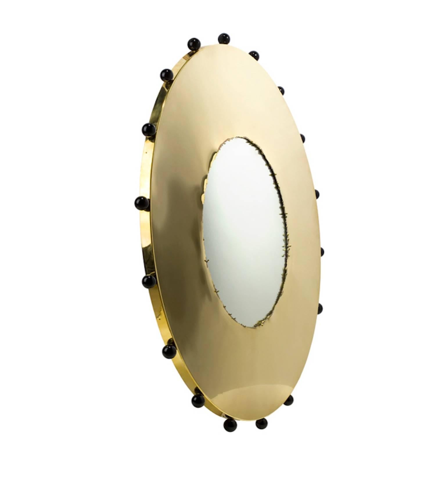The clown circle mirror is manufactured in Italy using polished brass with a torn liquid effect applied to the centre of the brass. The design is finished with hand formed Murano glass orbs.
The brass is un-lacquered and natural so will take on a