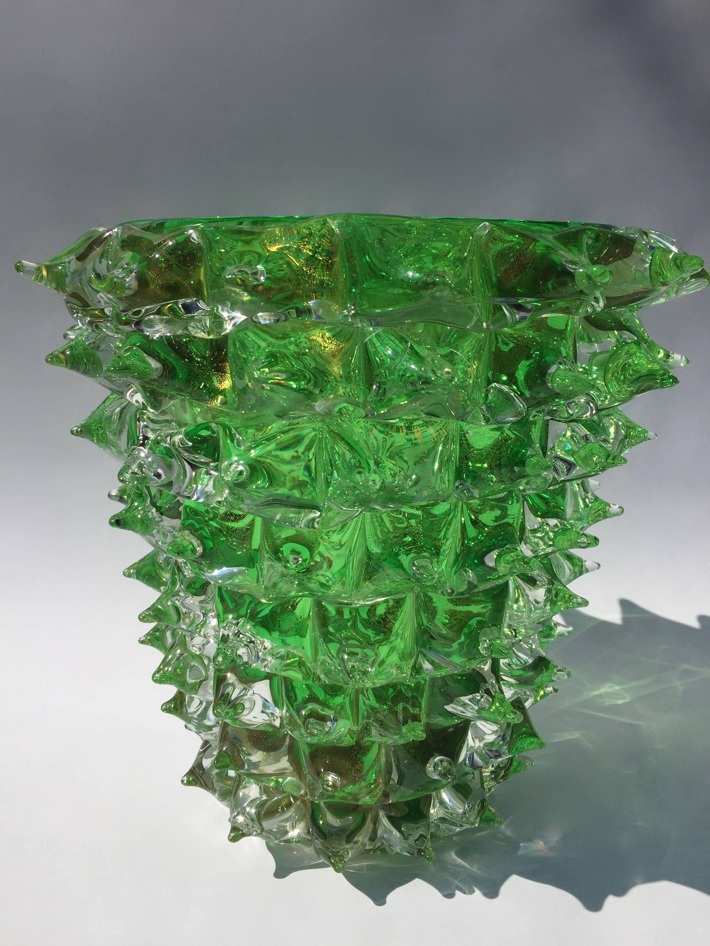A pair of exquisite Murano vases by the renowned Murano artist Costantini. Green and clear glass pulled into peaks decorate the outside of the vase. Gold leaf is applied to the vase during creation to give a speckled and iridescent effect to the