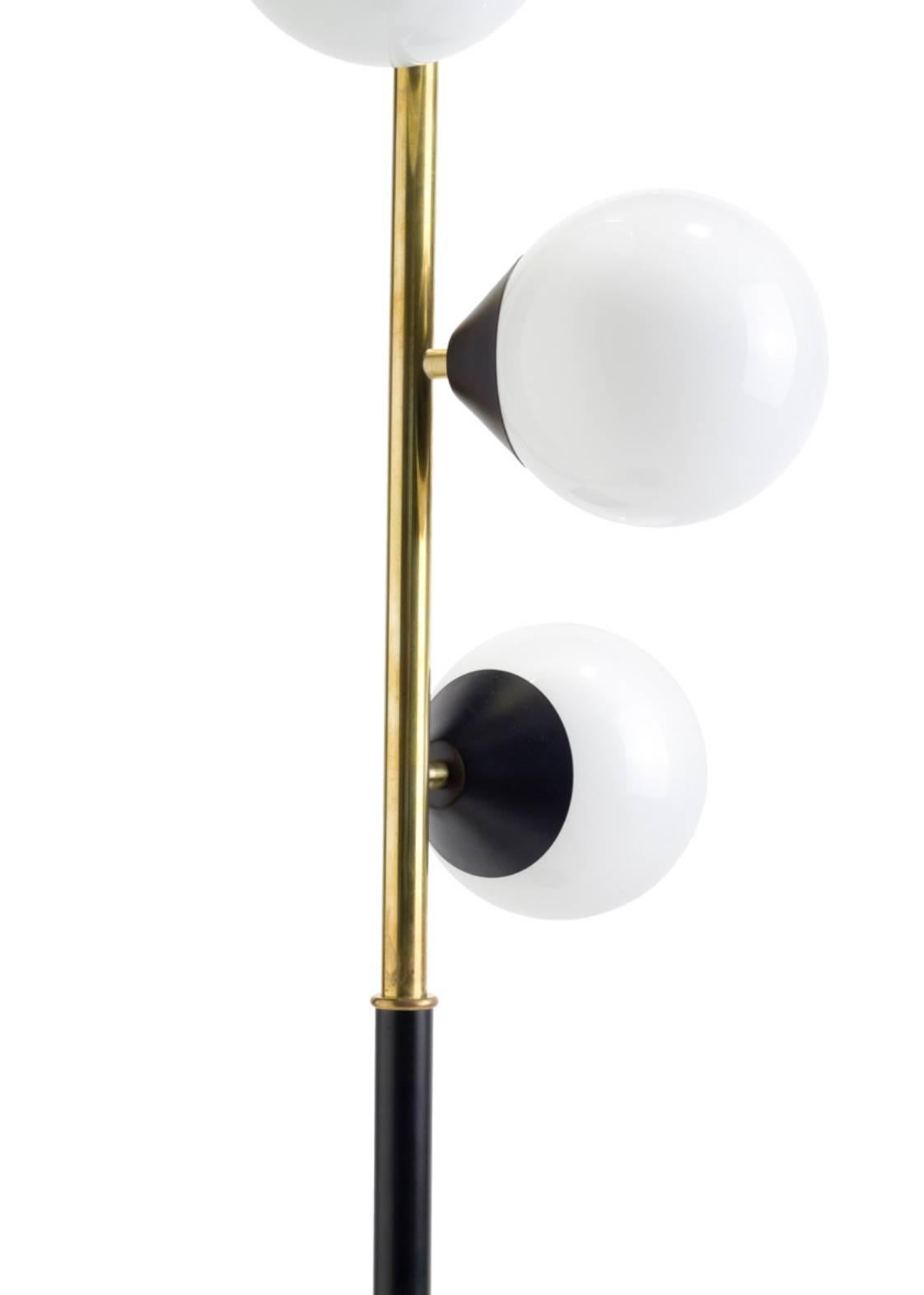 Five white glass orb floor lamp with metal and brass base.