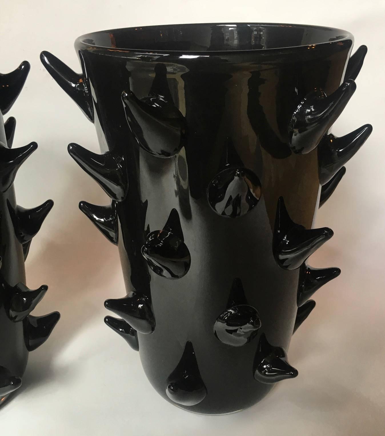 A pair of exquisite Murano Vases by the renowned Murano artist Costantini. Black glass pulled into peaks decorate the outside of the vase. Signature on the bottom of each vase.