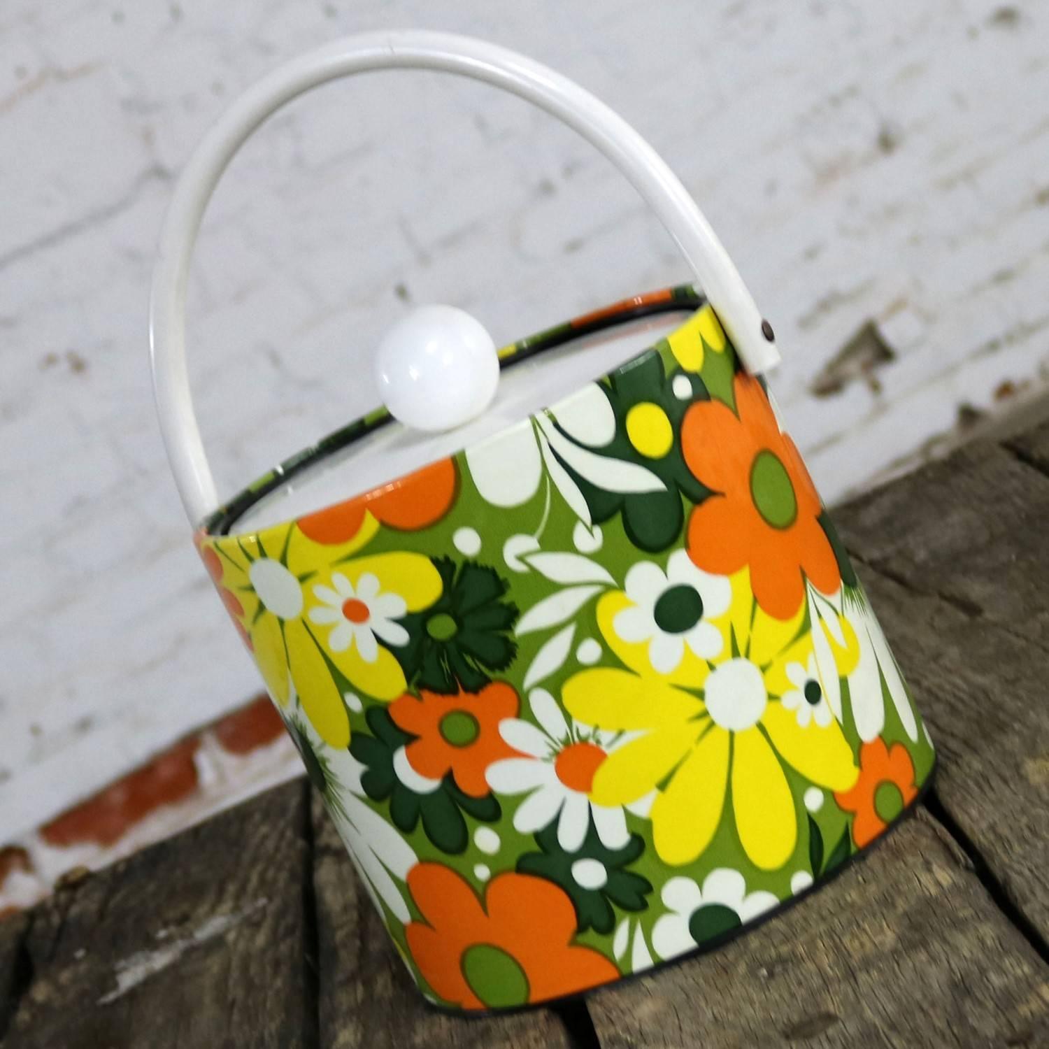 Fun vintage Mid-Century Modern orange, green, yellow and white daisy or floral ice bucket by Jack Frost Ice Buckets. This great plastic ice bucket is in wonderful vintage condition, circa 1960s-1970s.

You are going to go ape over this groovy ice