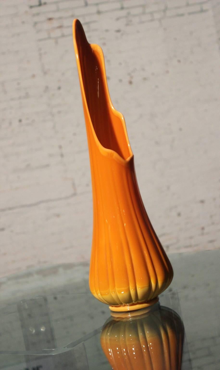 Incredible, gorgeous, monumental, fabulous! Yellow orange to bittersweet orange opaque glass stretch vase most likely by Viking Glass in wonderful vintage condition with no chips, cracks or chiggers.

Just take a look at this monumental sized and