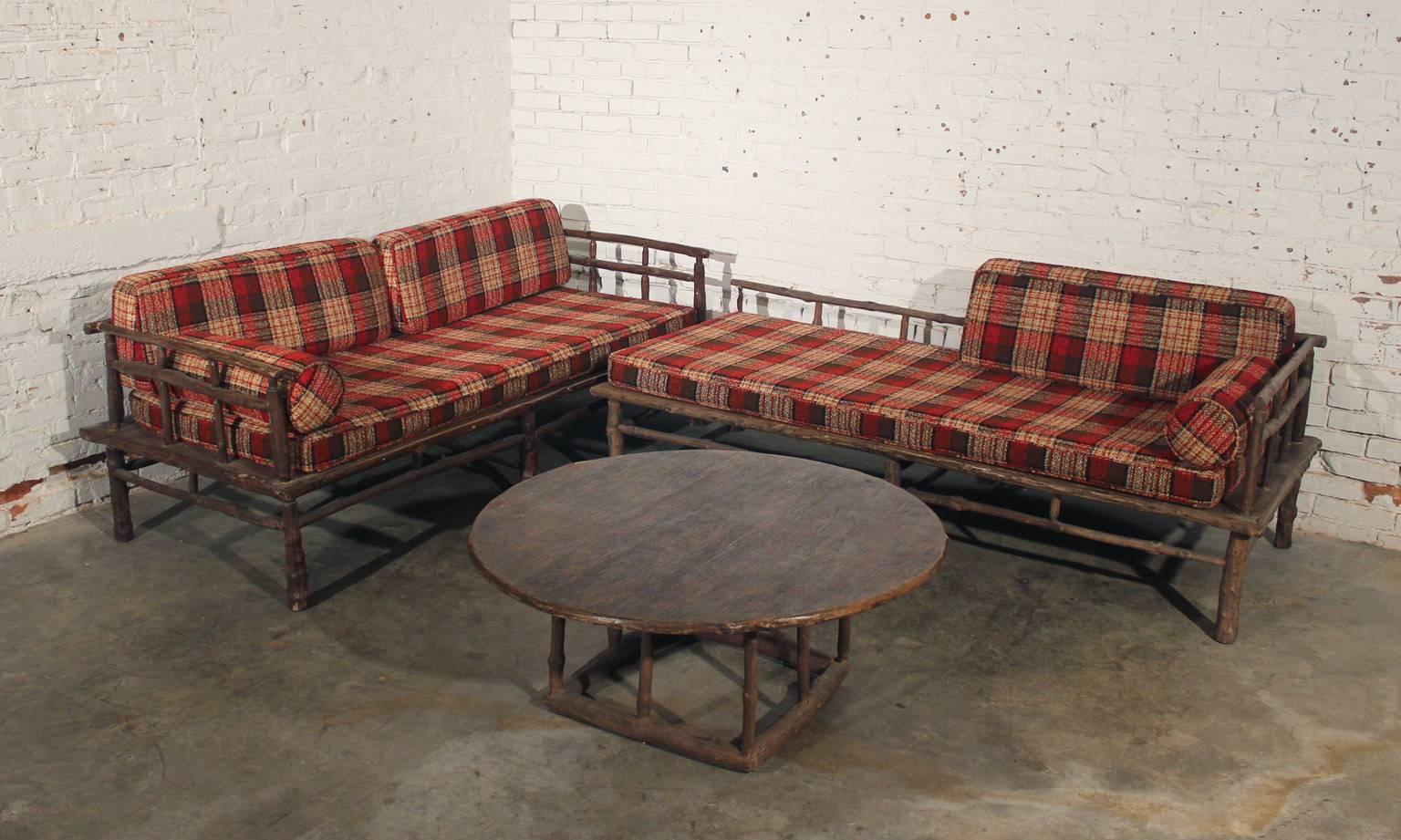 1950s Old Hickory style sofa, chaise and round coffee or end table. Sofa, chaise and coffee table are made of old hickory, circa 1950s. Sofa and chaise come with two, bench style seat cushions, four back cushions and two round arm cushions. All