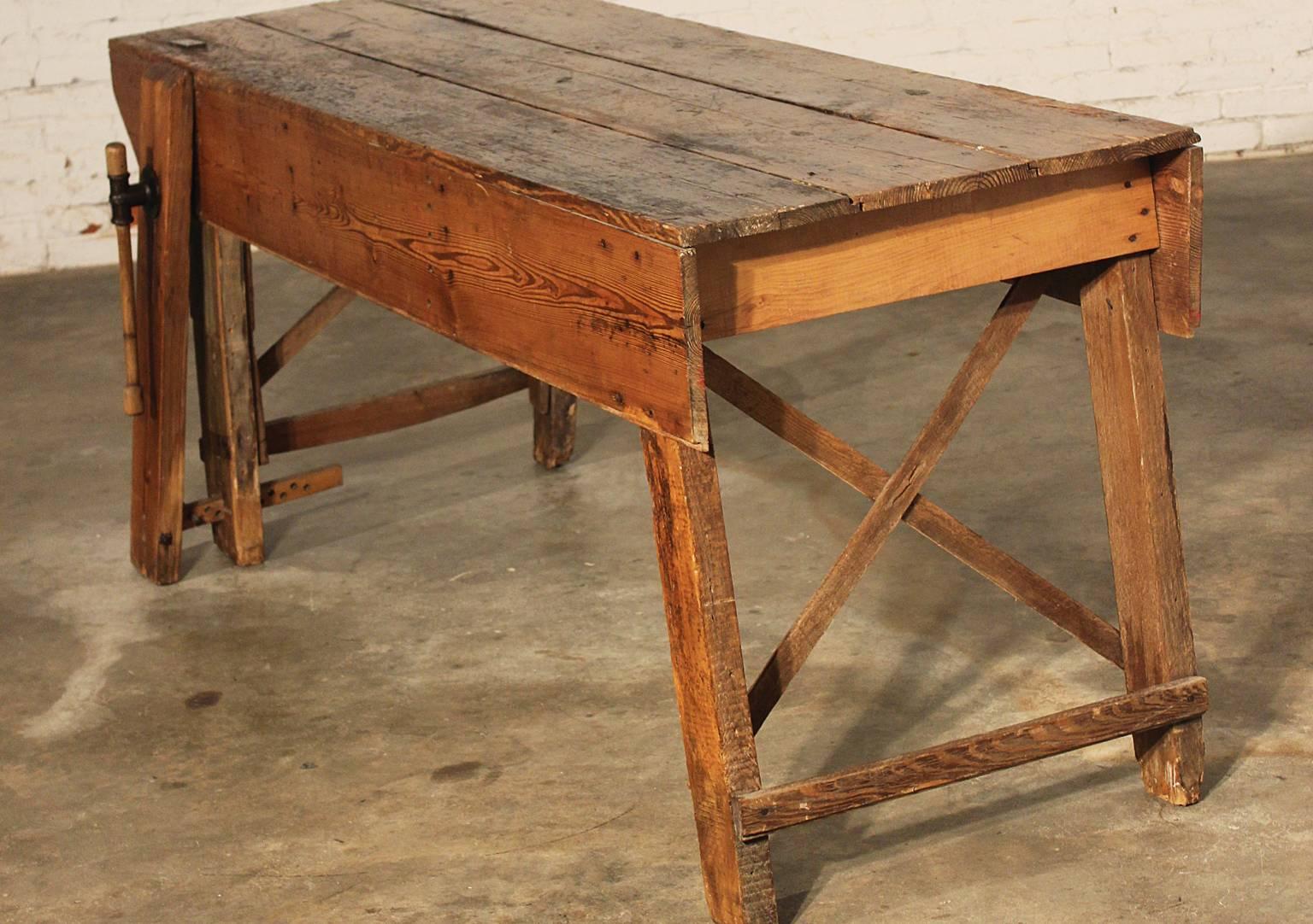 Just look at the gorgeous age patina on this fabulous primitive industrial farmhouse style pine dining table workbench. It even has its own integral wood vise attached to one of the legs. This piece makes an awesome dining table ( of course with the