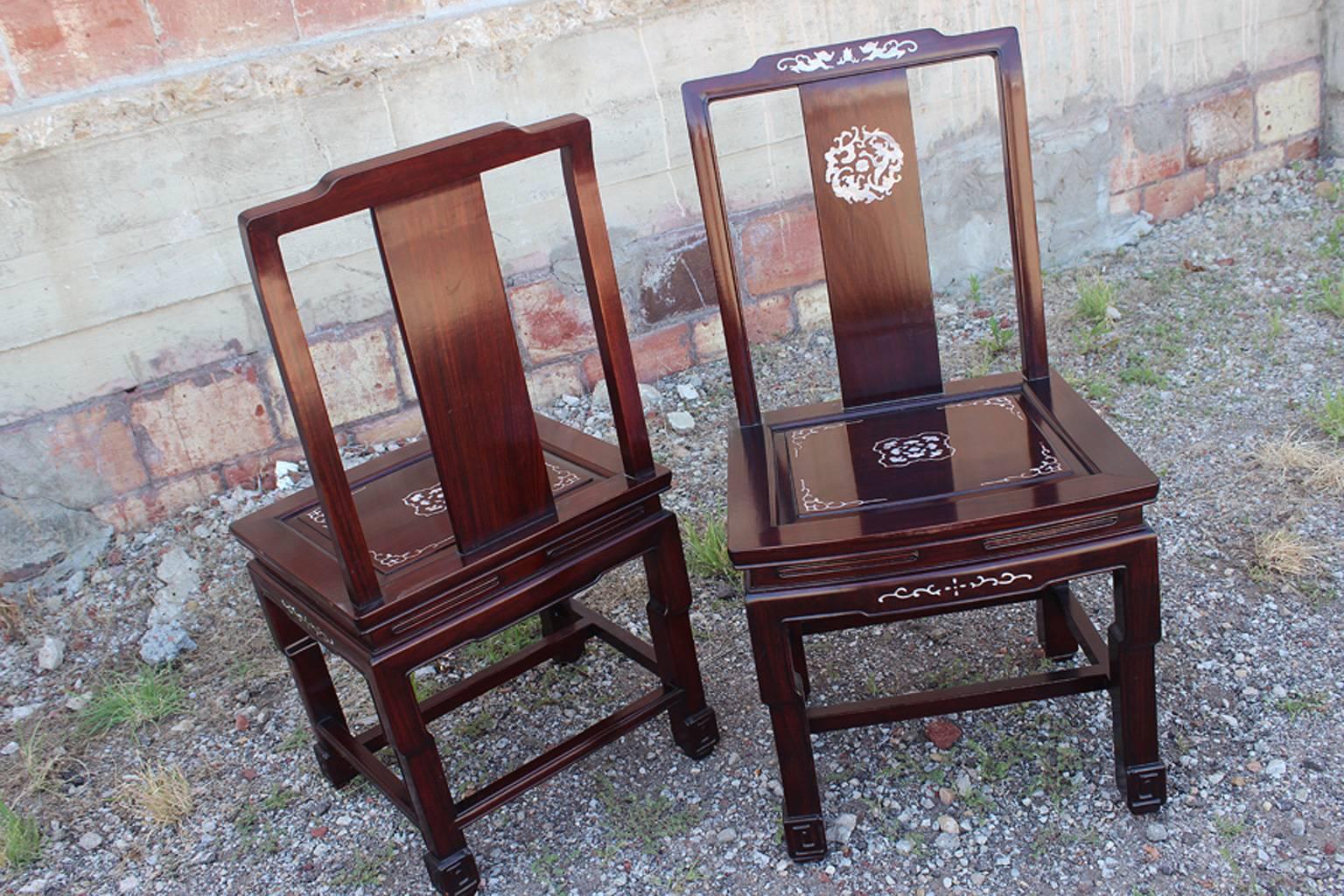 Awesome! Let's just get that out there first. This set of eight Chinese rosewood and mother-of-pearl vintage dining chairs are simply awesome! I don't know what else to say. I hope the photos speak for themselves. Each chair is inlaid with intricate