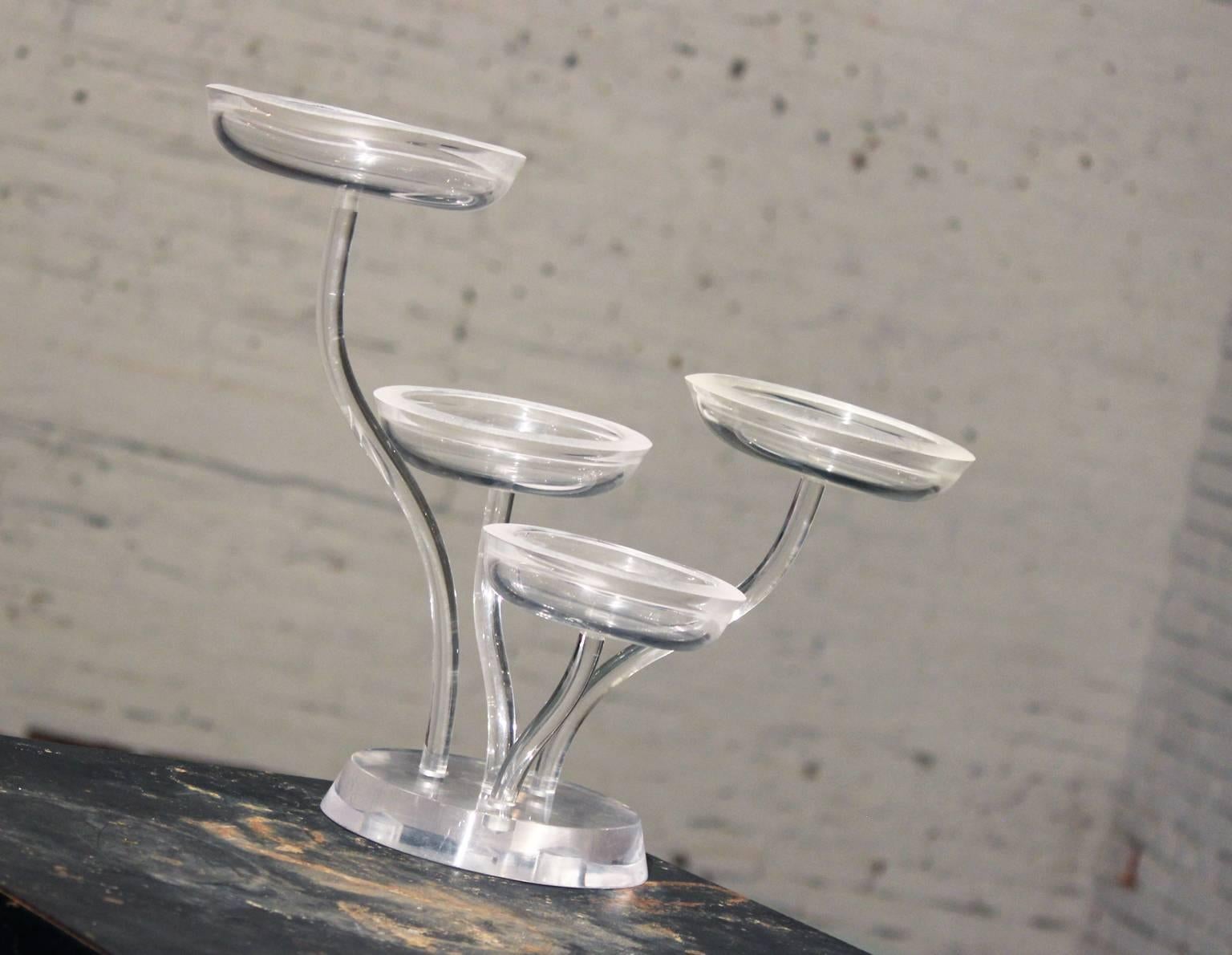 Beautiful and unusual Lucite four level candy dish or display piece. In wonderful vintage condition.

Ooh la la!! Look at this fabulous vintage Lucite four-part four-level candy dish or store display. Each individual Lucite arm is a different