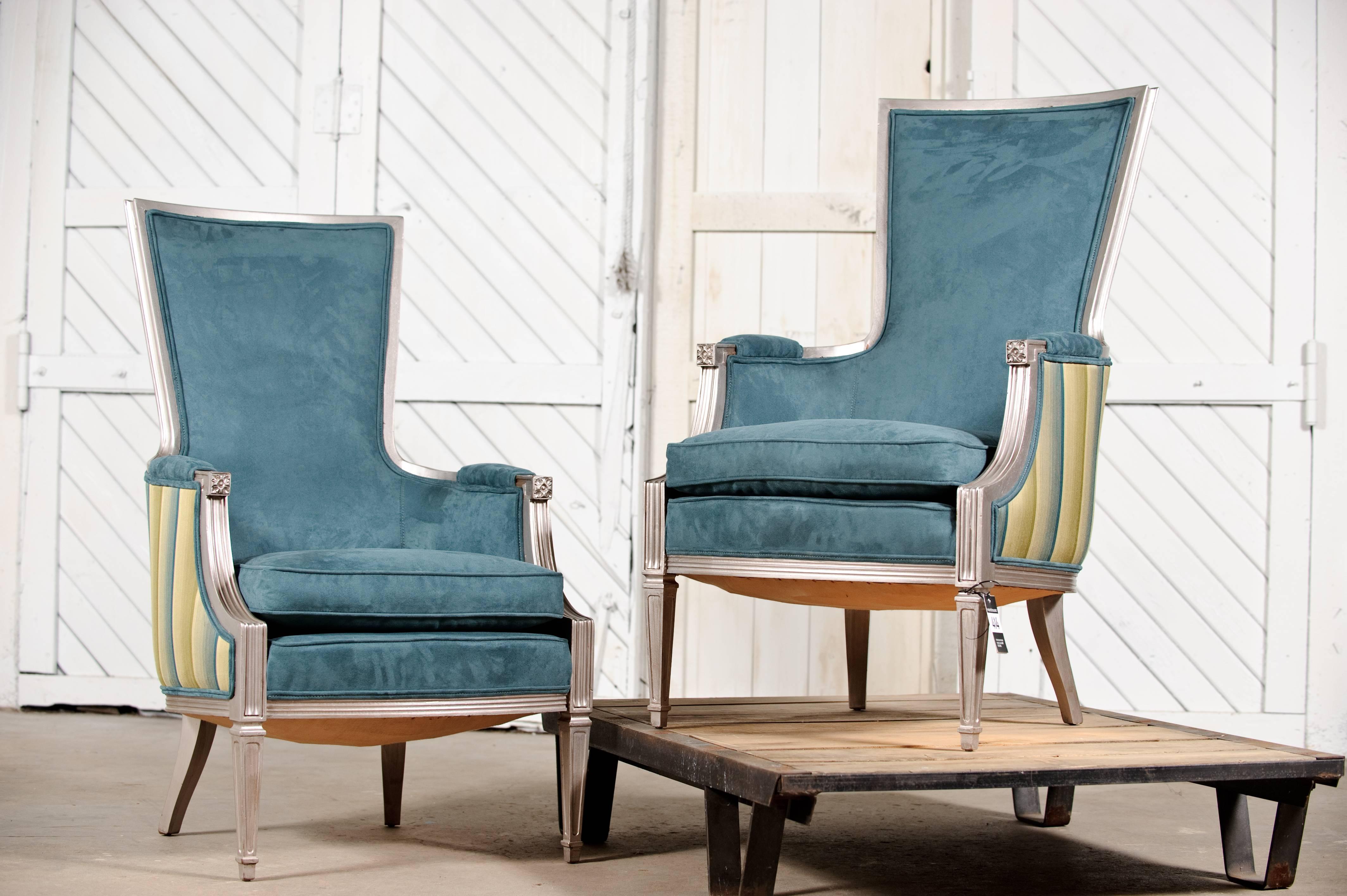 Neoclassic pair of chairs in aqua with silvered wood. Newly reupholstered in aqua ultrasuede fronts and aqua and green striped backs. The wood has been finished in a faux silver leaf. Beautiful revamped condition.

You have to love these newly
